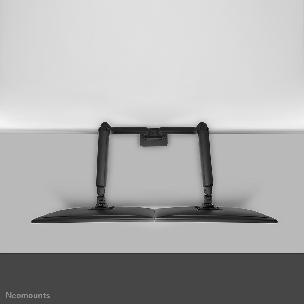 Two black monitors mounted on a dual arm desk stand, viewed from above.