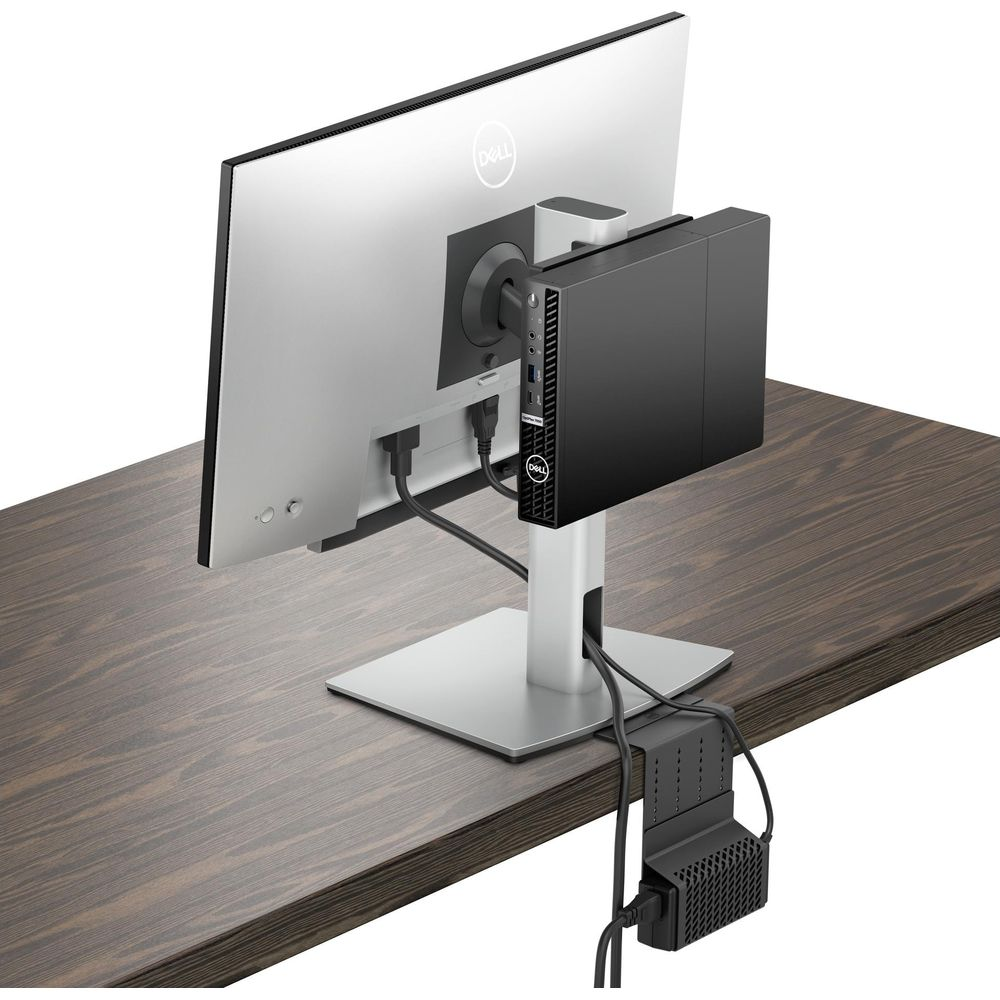 Un PC Dell è montato sul retro di un monitor appoggiato su una scrivania.