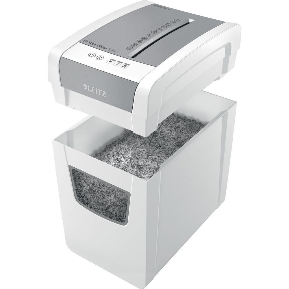 Une déchiqueteuse à papier blanche avec une poubelle pleine de papier déchiqueté.