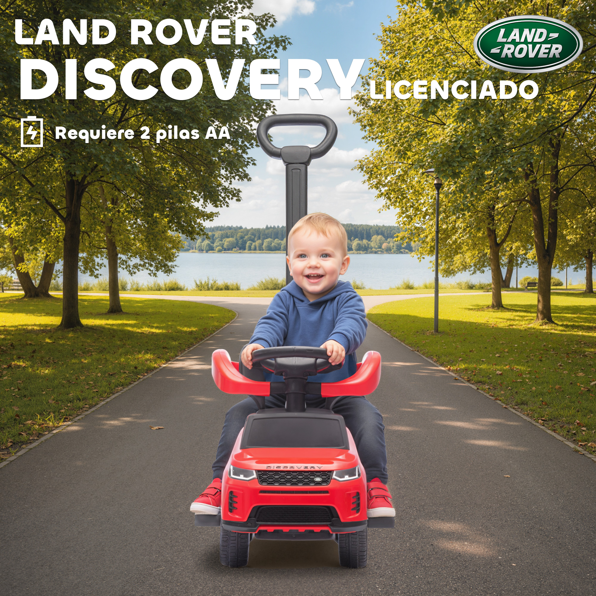 Un niño se sienta en un coche de juguete rojo Land Rover Discovery al aire libre.