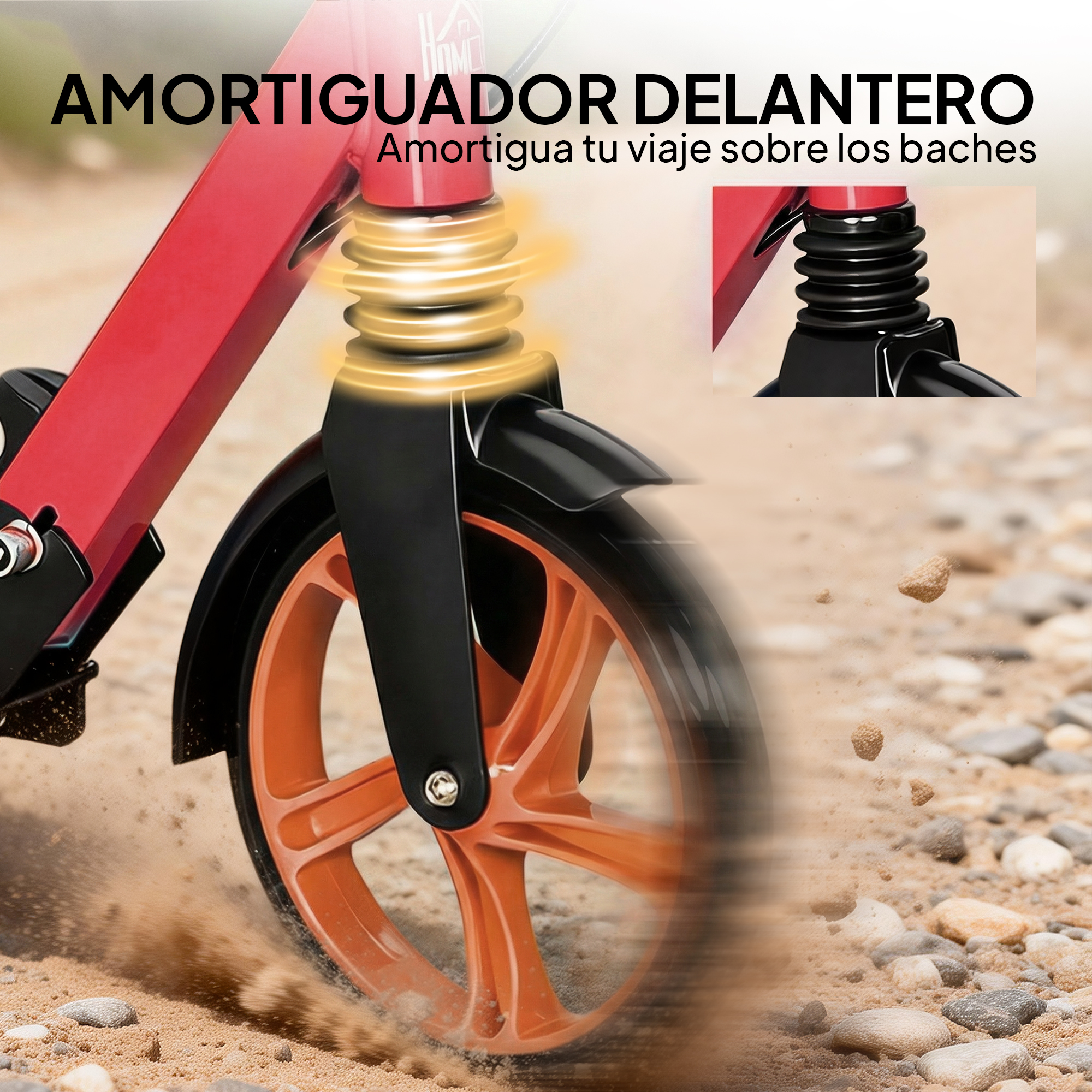 Amortiguador delantero de un patinete rojo sobre superficie arenosa.