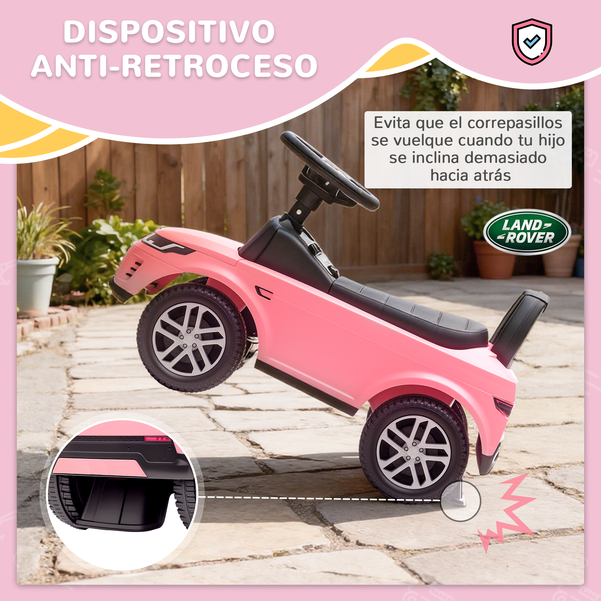 Un coche de juguete rosa con logo Land Rover está en un patio.