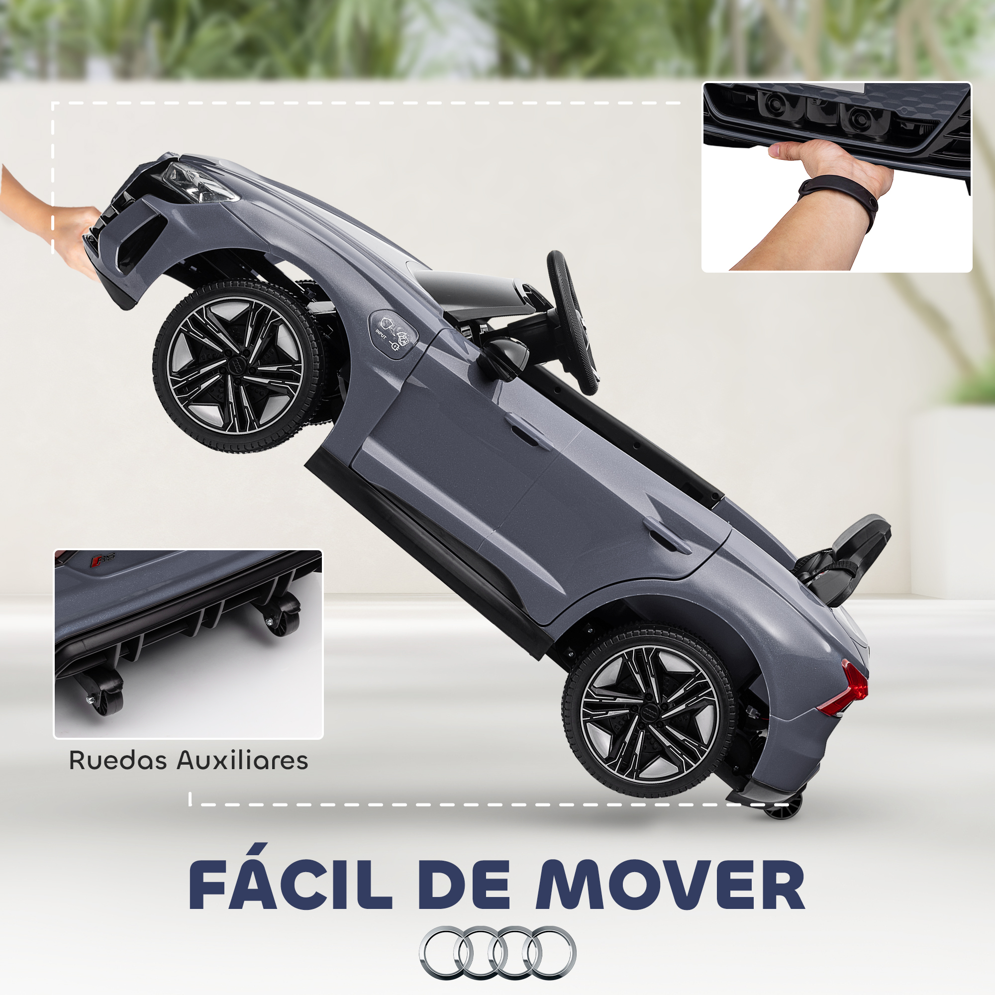 Un coche de juguete gris se muestra levantado sobre sus ruedas traseras con una mano sujetando el parachoques delantero, destacando su portabilidad.