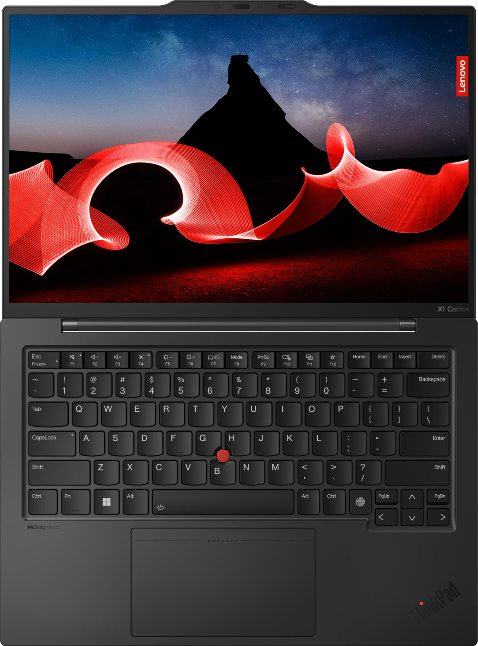 Un laptop con schermo che mostra una notte stellata e pittura di luce rossa.