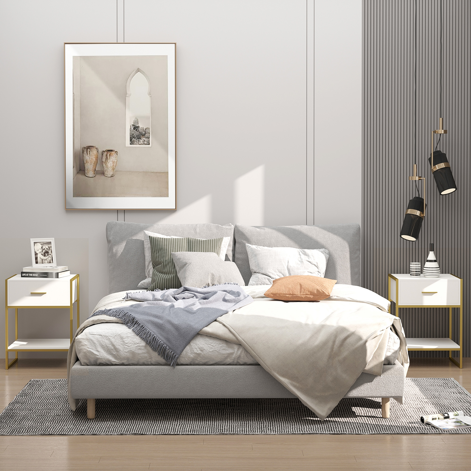 Un dormitorio moderno con cama gris, mesitas y cuadros en la pared.
