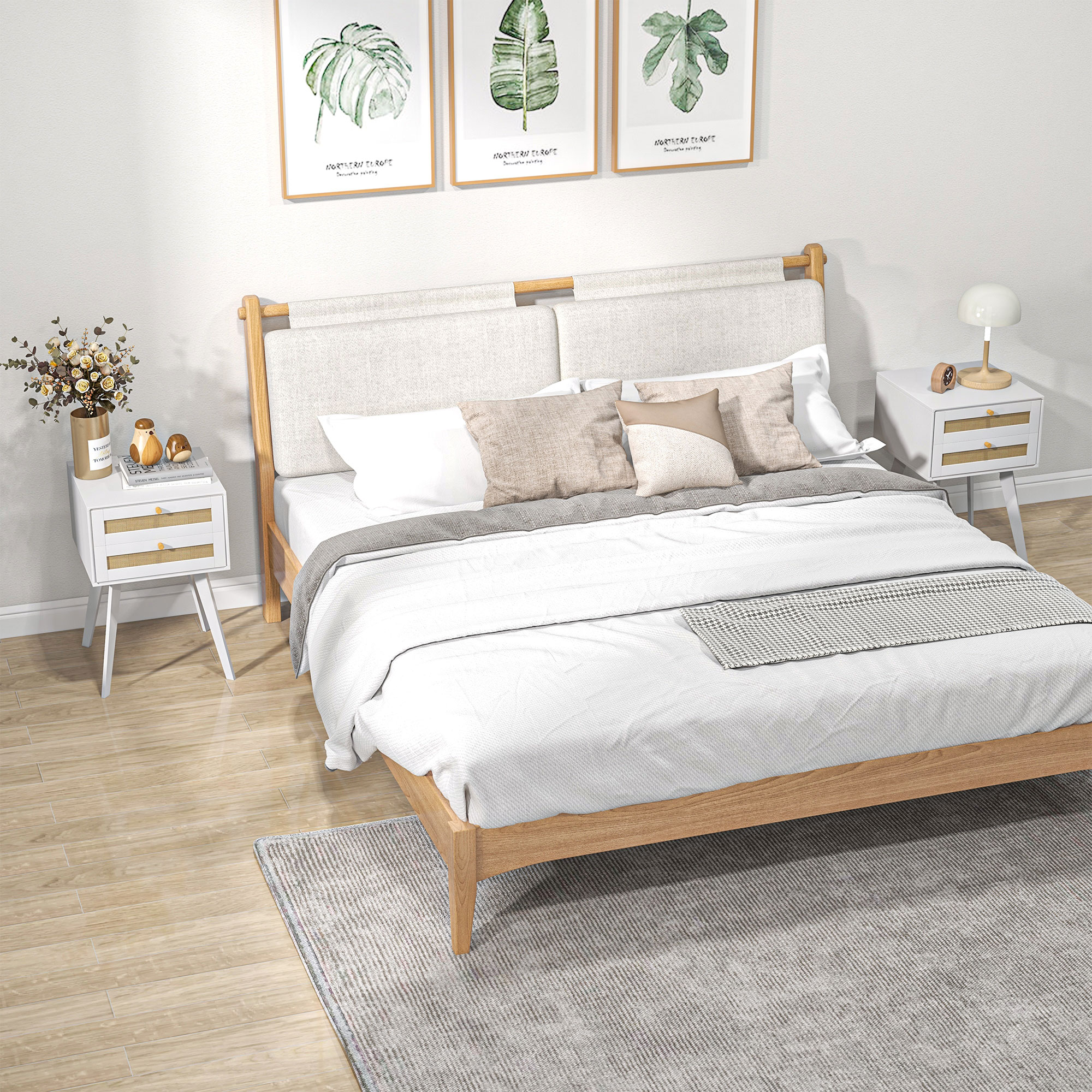 Una escena de dormitorio con cama de madera, mesitas de noche blancas y tres láminas botánicas.