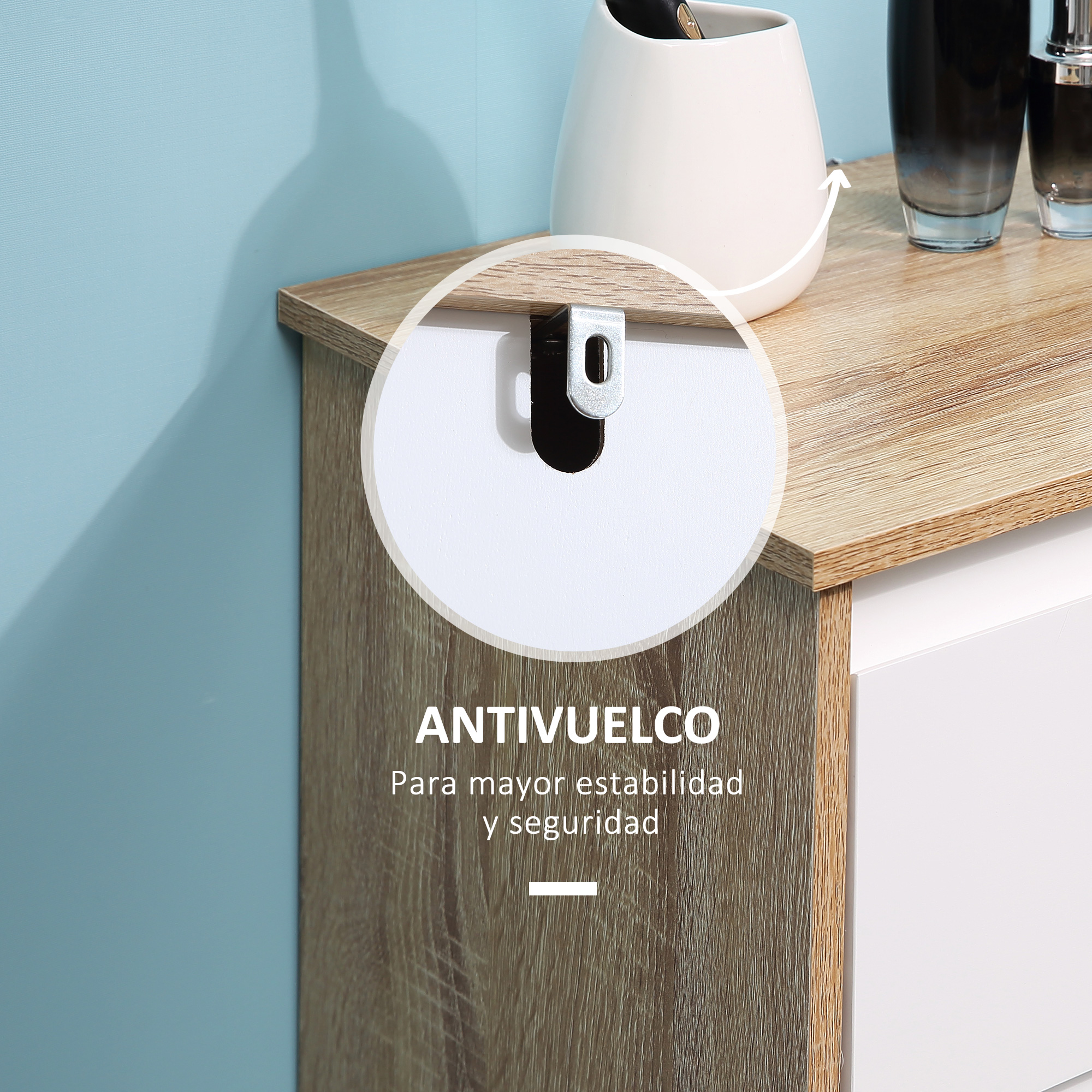 Primer plano de un soporte antivuelco en un mueble de madera con cajón blanco.
