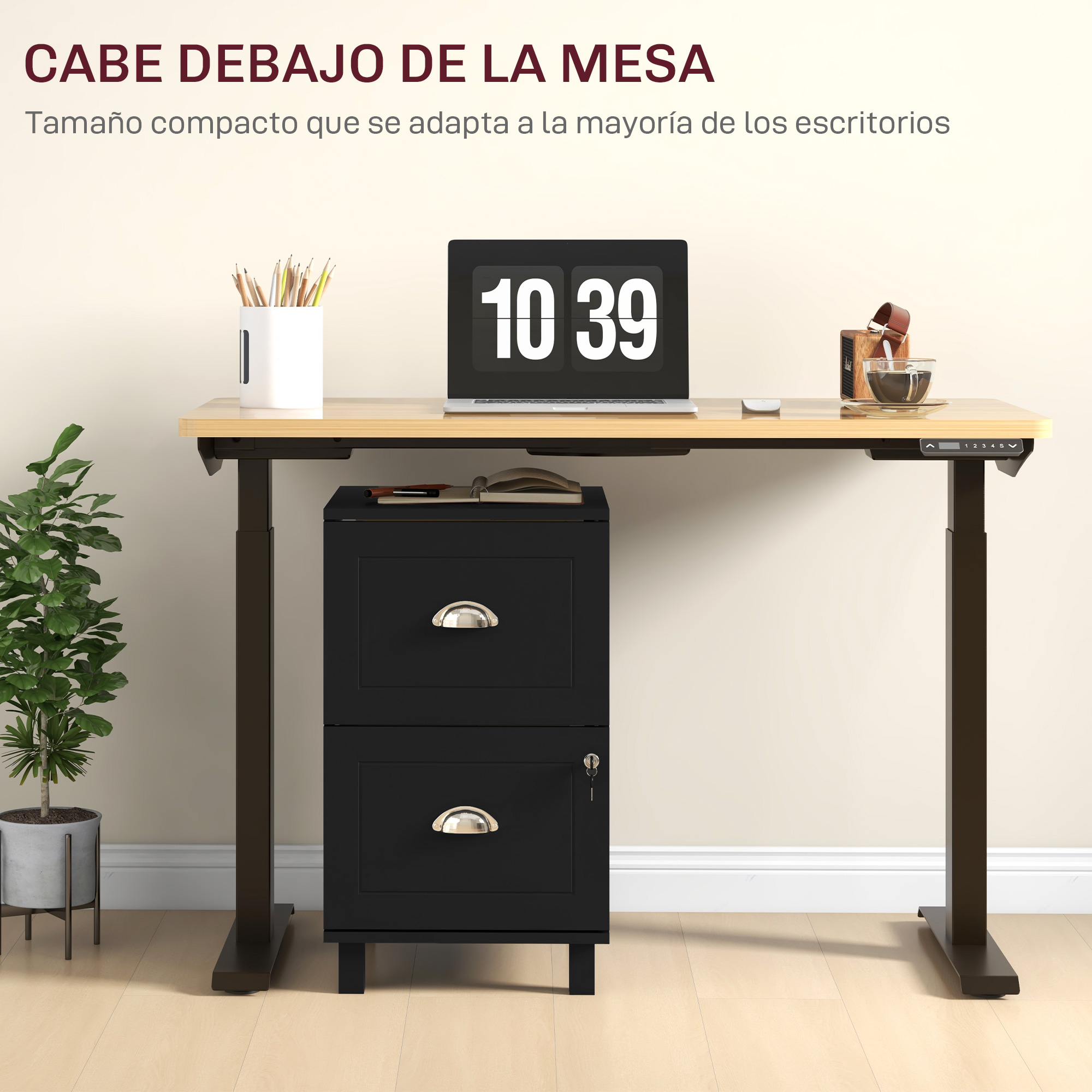 Un archivador negro bajo un escritorio ajustable con portátil, taza y planta.