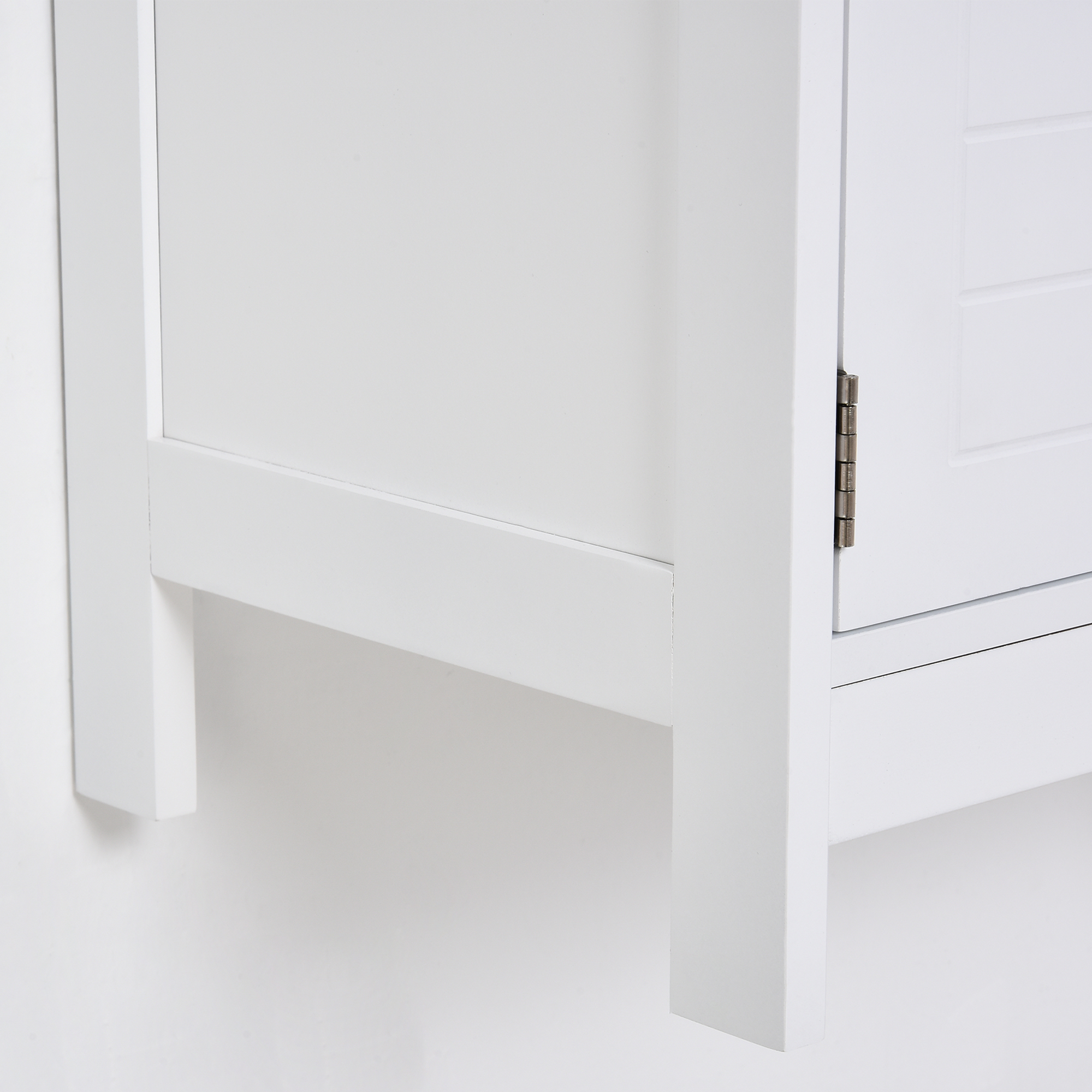 Esquina de armario blanco con bisagra metálica y detalle de puerta panelada.