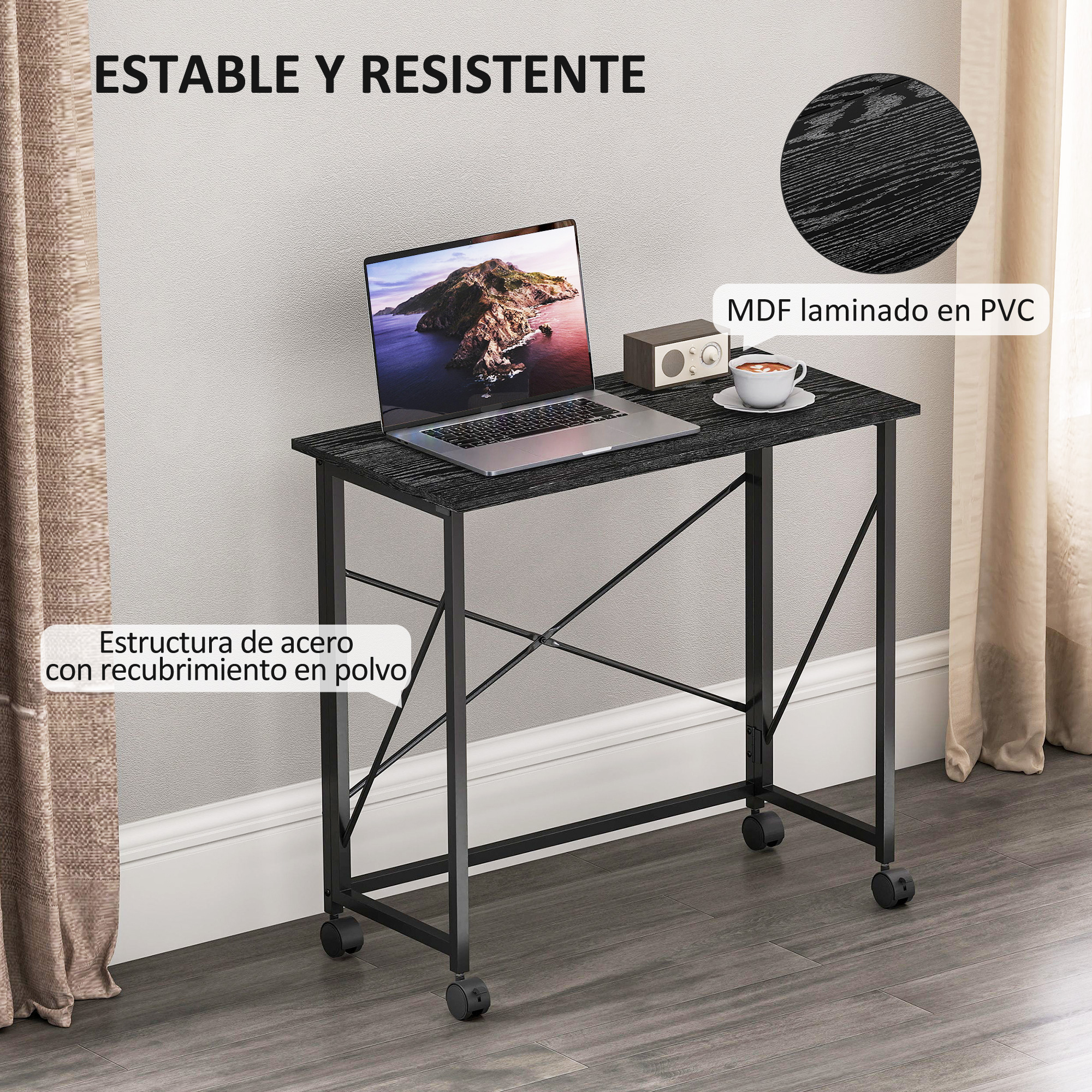 Escritorio negro con laptop, radio y taza de café con ruedas.
