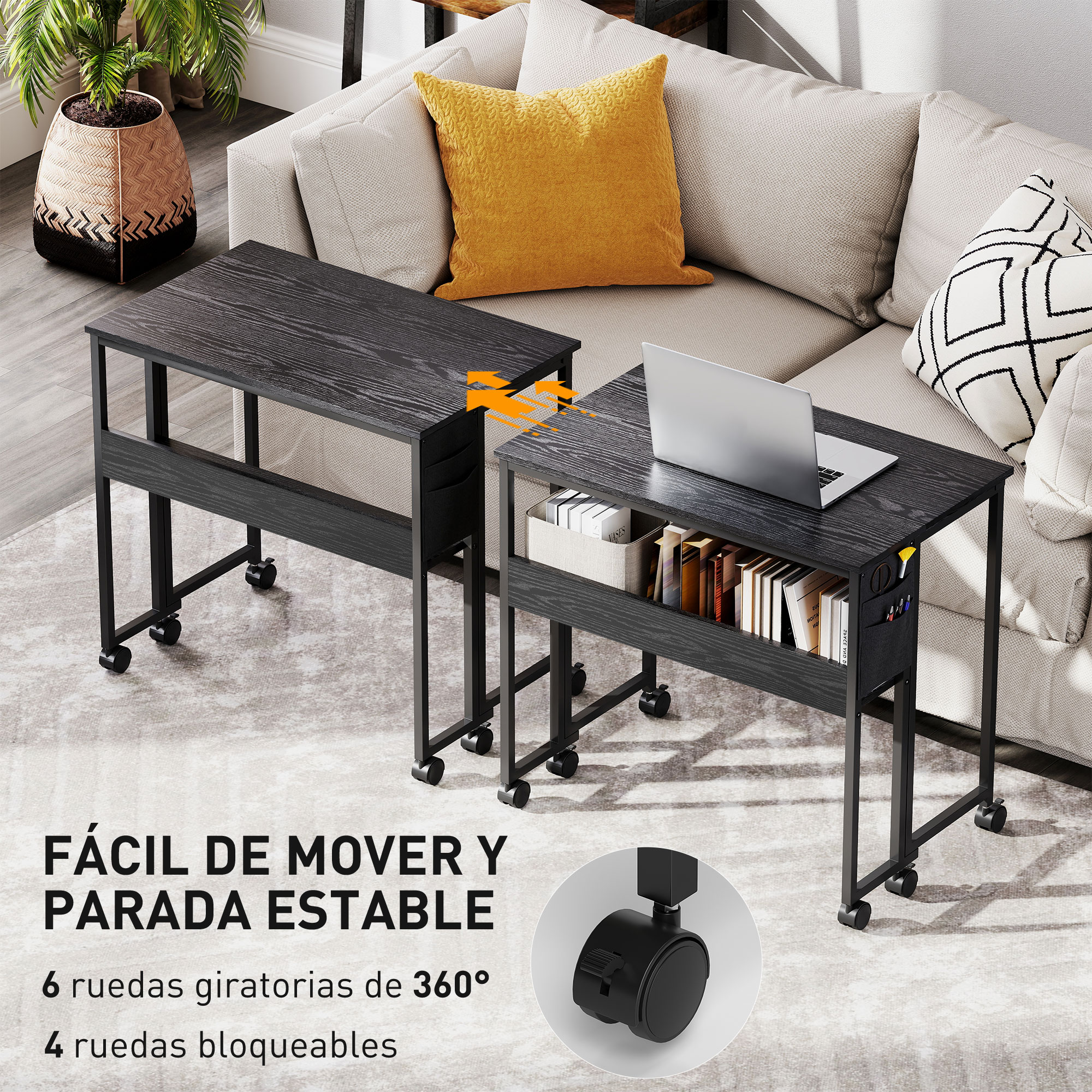Dos mesas auxiliares negras con ruedas frente a un sofá con cojines. Una tiene portátil y libros.