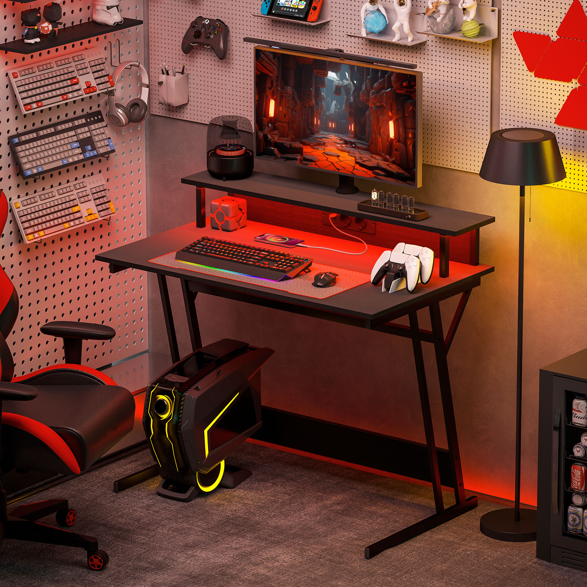 Un escritorio de juegos con monitor, teclado, ratón, mandos y silla.