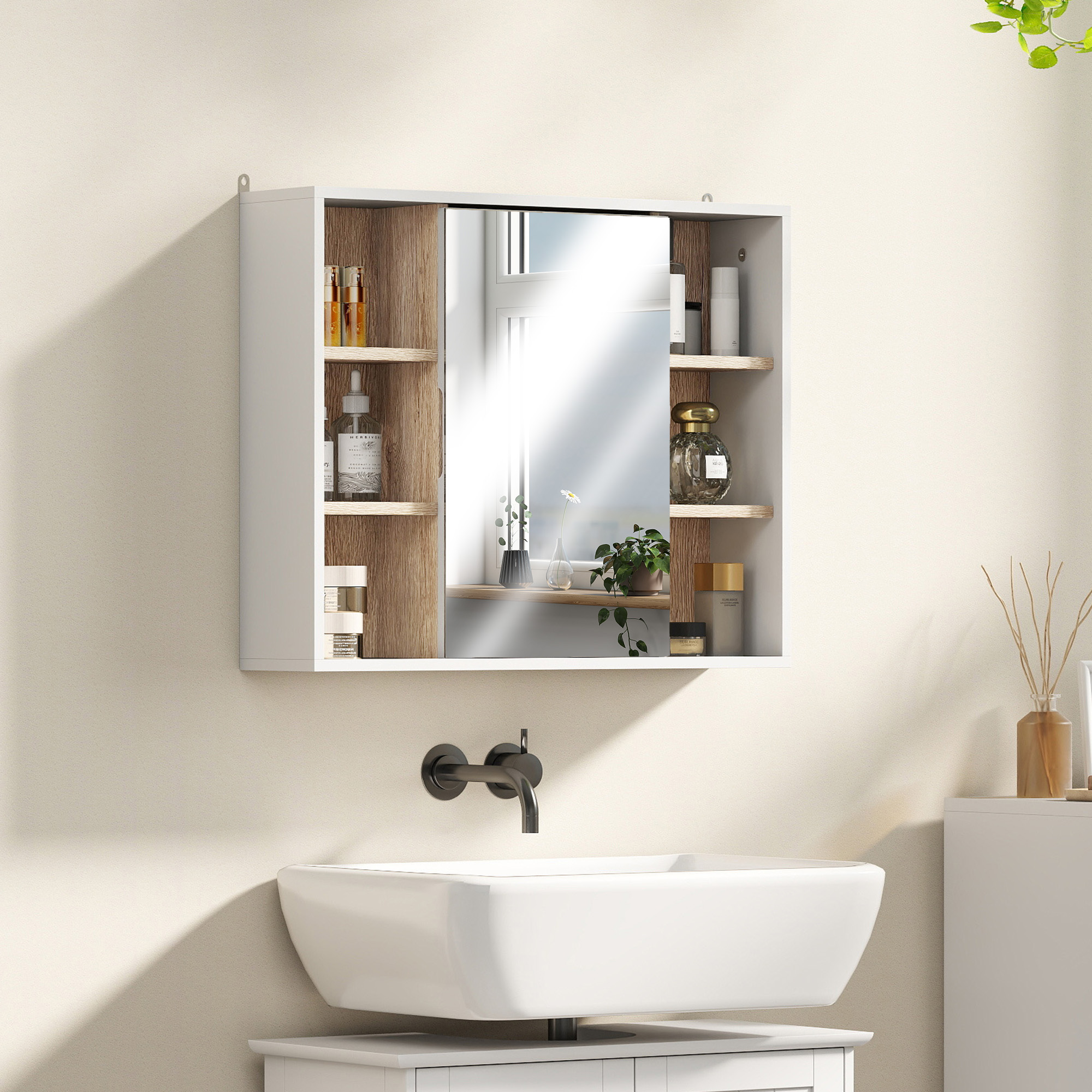 Un mueble de baño blanco con espejo sobre un lavabo con grifo.