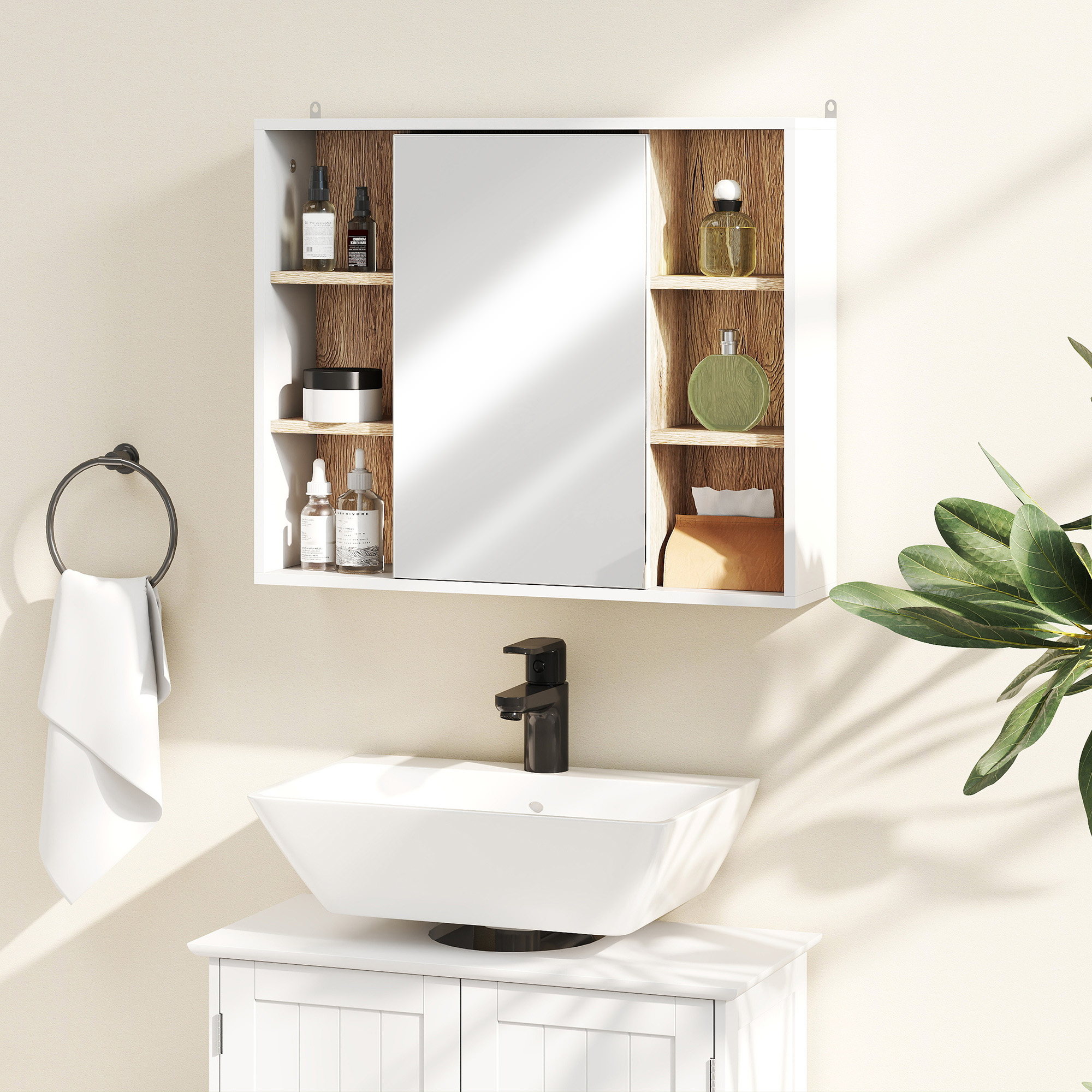 Un mueble de baño con espejo, lavabo, grifo y toallero.