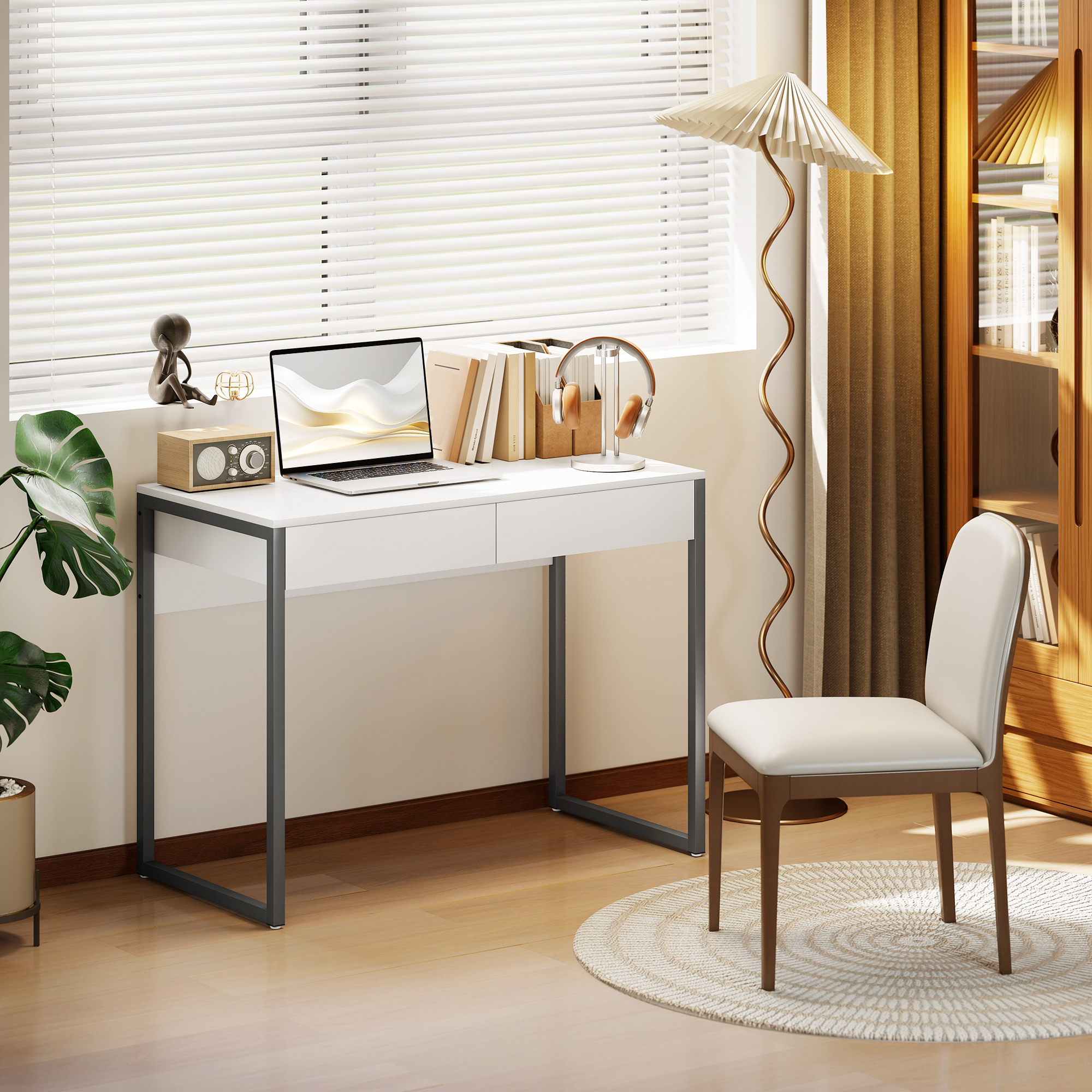 Un escritorio blanco con portátil, auriculares, libros y una lámpara.