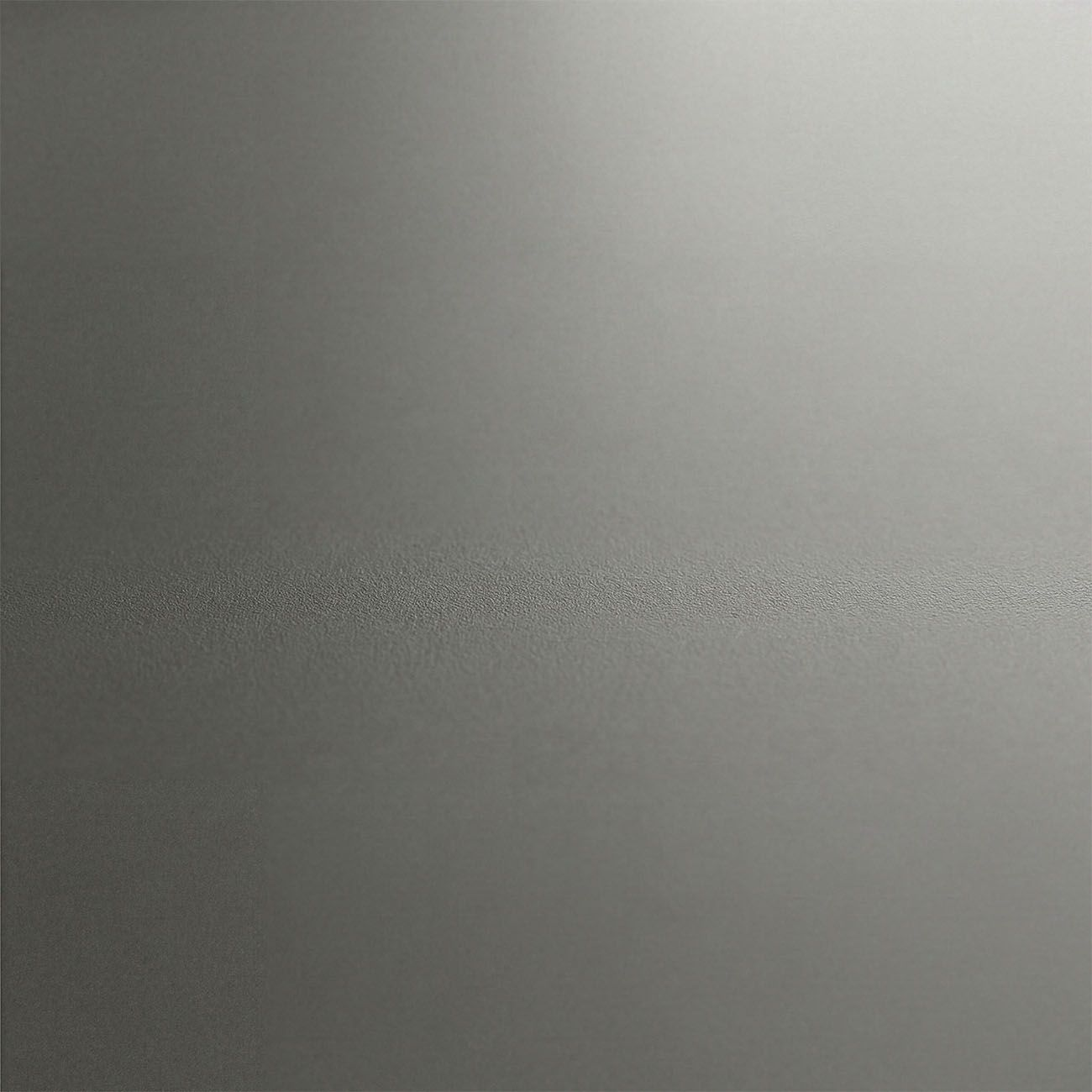 Una textura gris y granulada con un degradado de luz de izquierda a derecha.