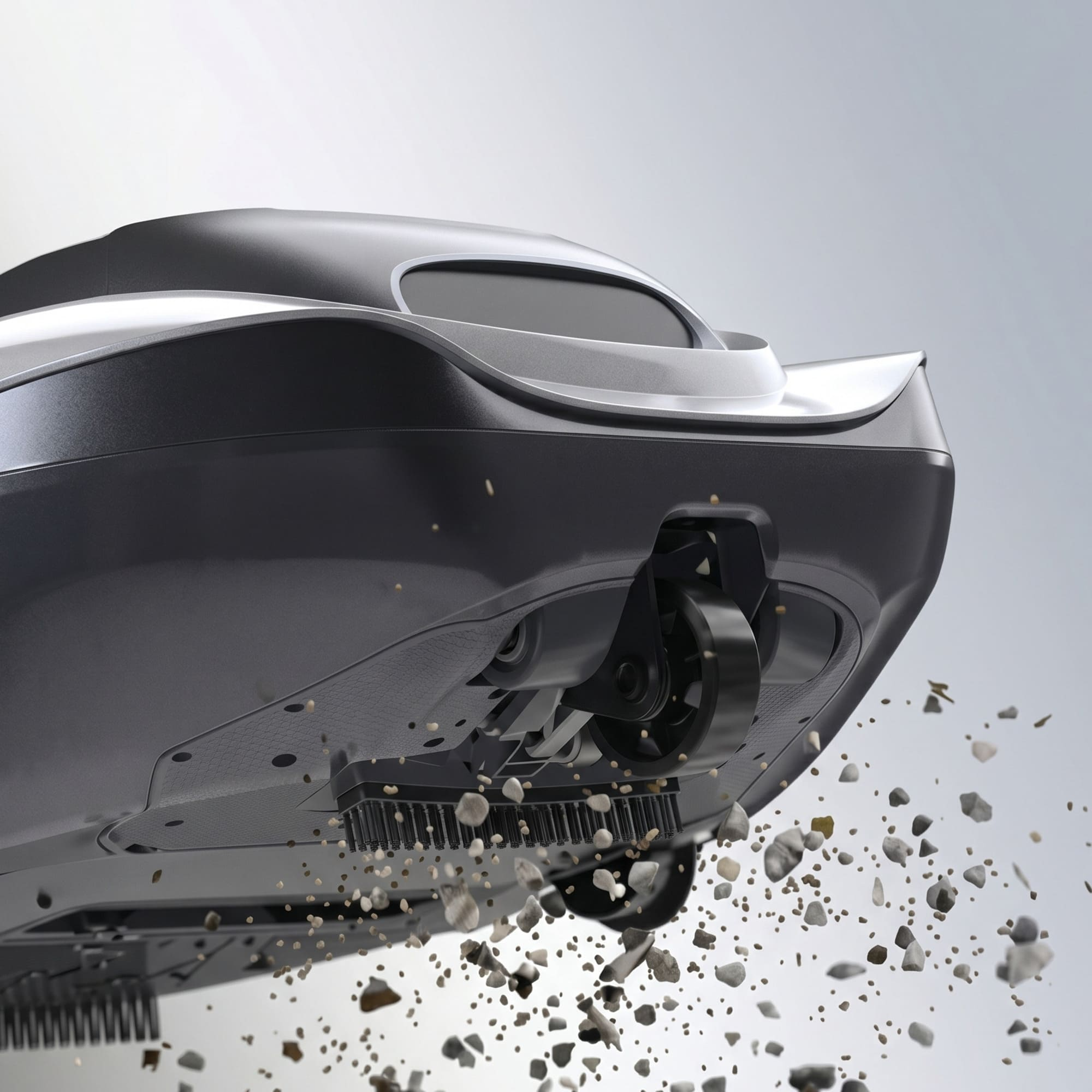 Un robot aspirador recoge piedras. Primer plano de la parte inferior y los cepillos.