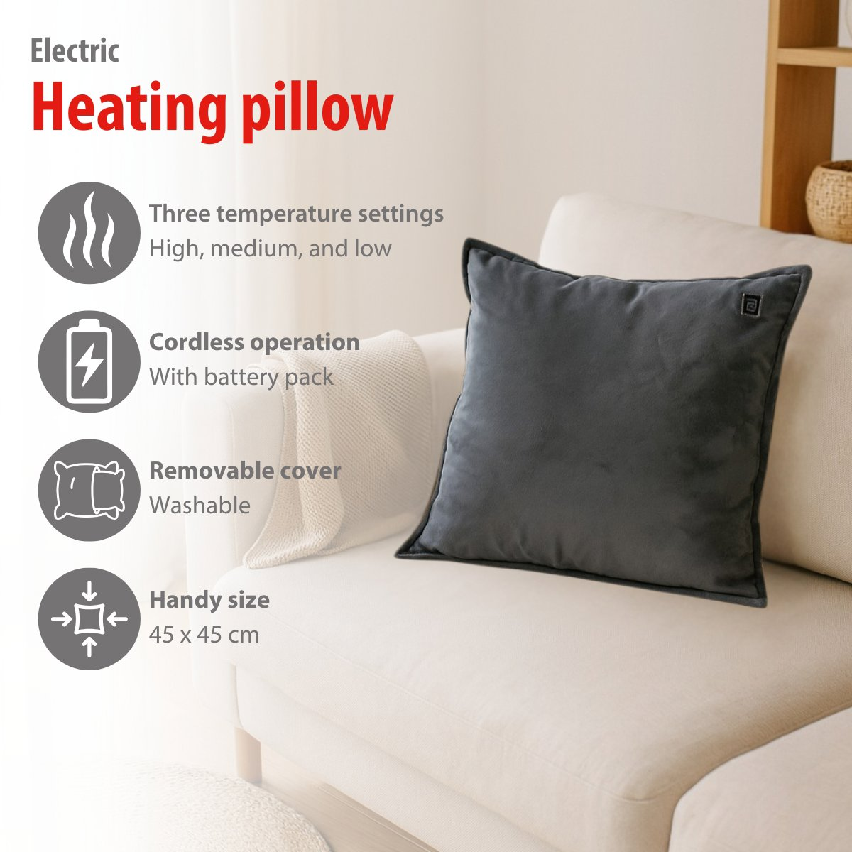 Dark gray heating pillow with feature icons on a sofa.