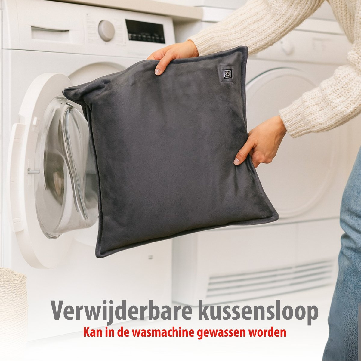 Grey heated pillow being removed from washing machine. Tag visible.