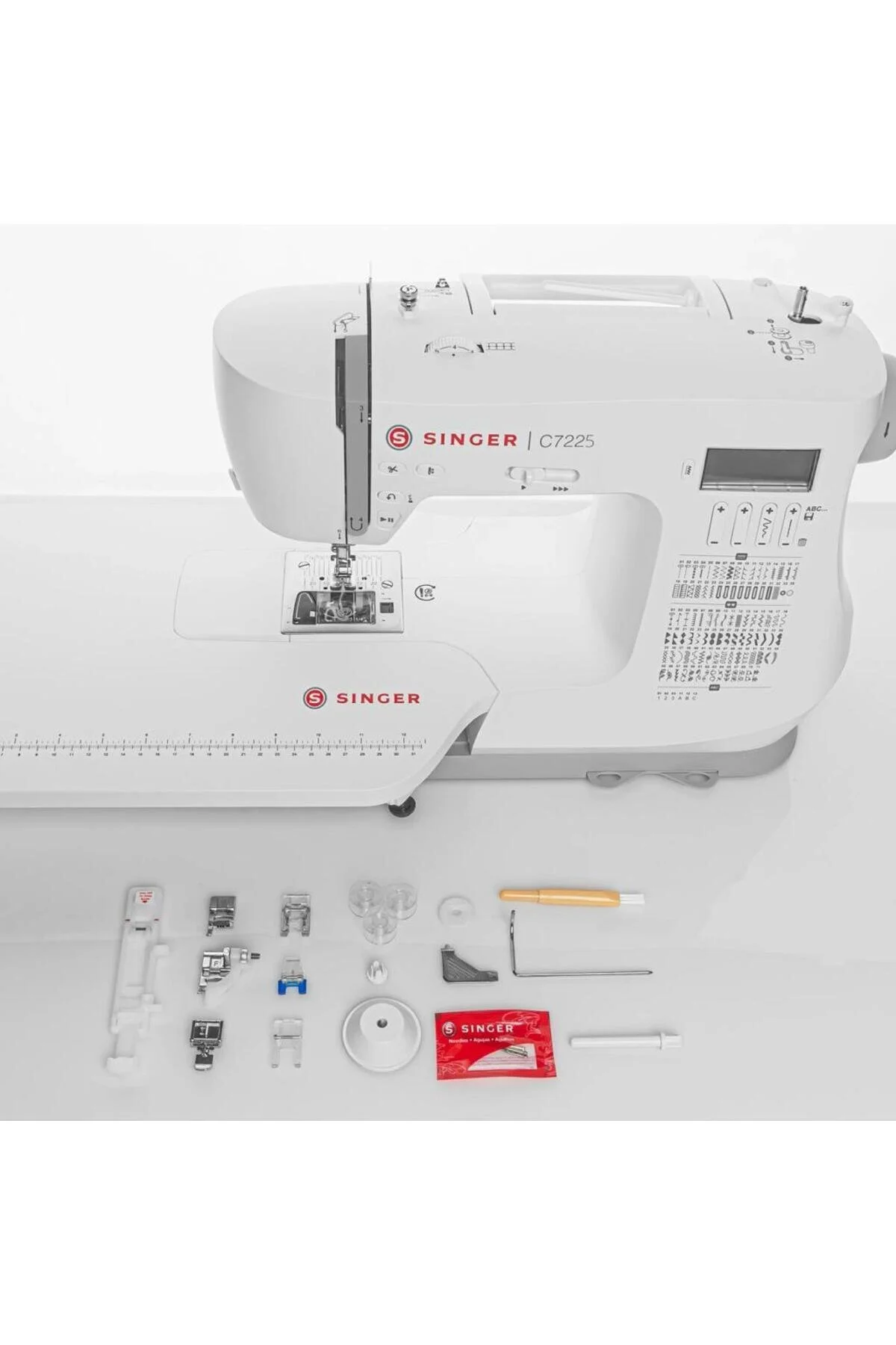 Weiße Singer Nähmaschine C7225 mit Zubehör wie Nähfüßen, Spulen und Nadeln.