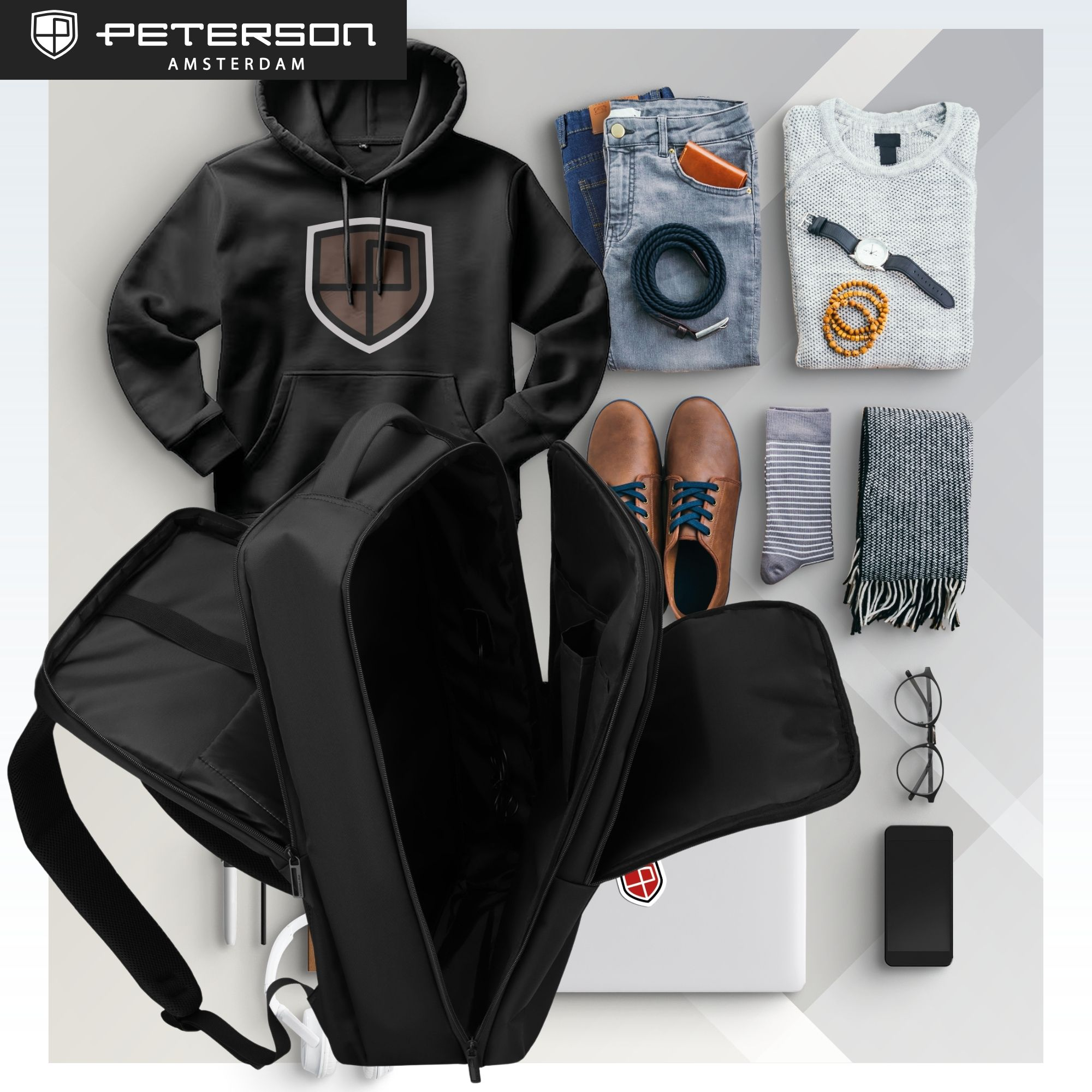 Czarna bluza z kapturem, dżinsy, buty, skarpetki, szalik, sweter, plecak, laptop, telefon, okulary.
