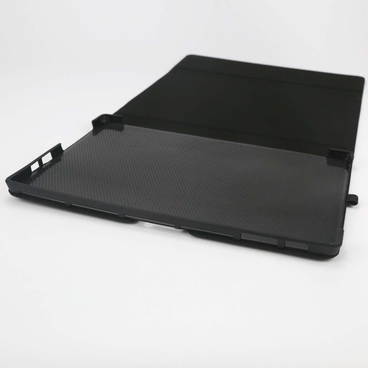 Ein schwarzes Tablet-Etui mit Wabenmuster auf der Innenseite, auf weißem Hintergrund.