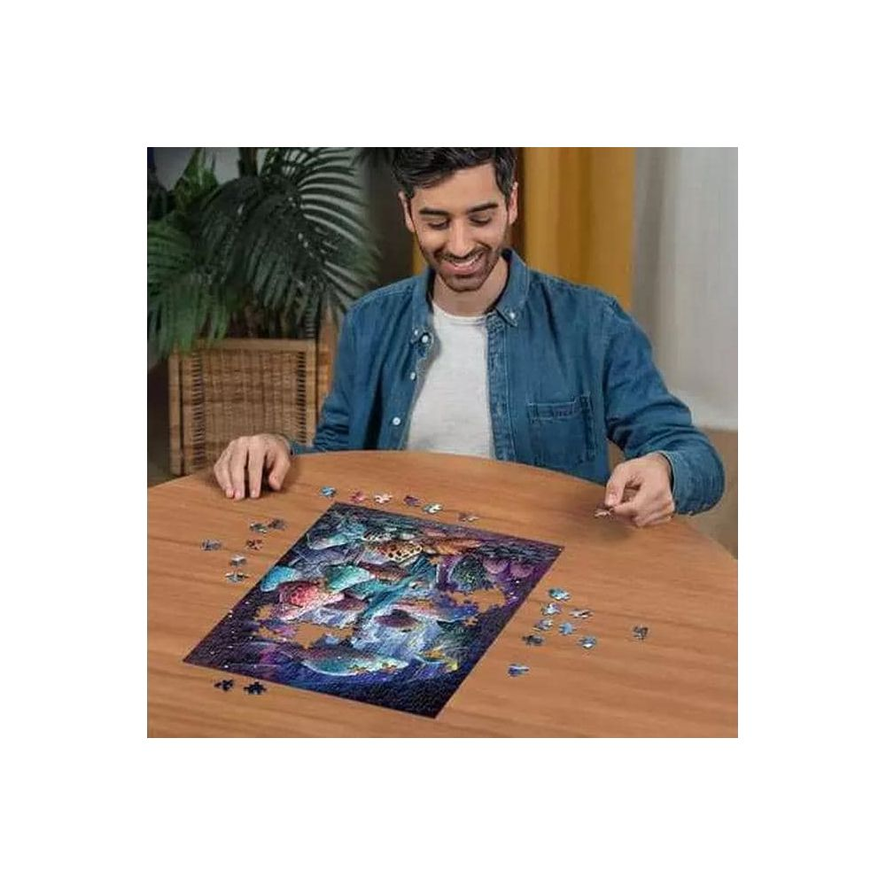 Uomo completa un puzzle di creature marine su un tavolo di legno.