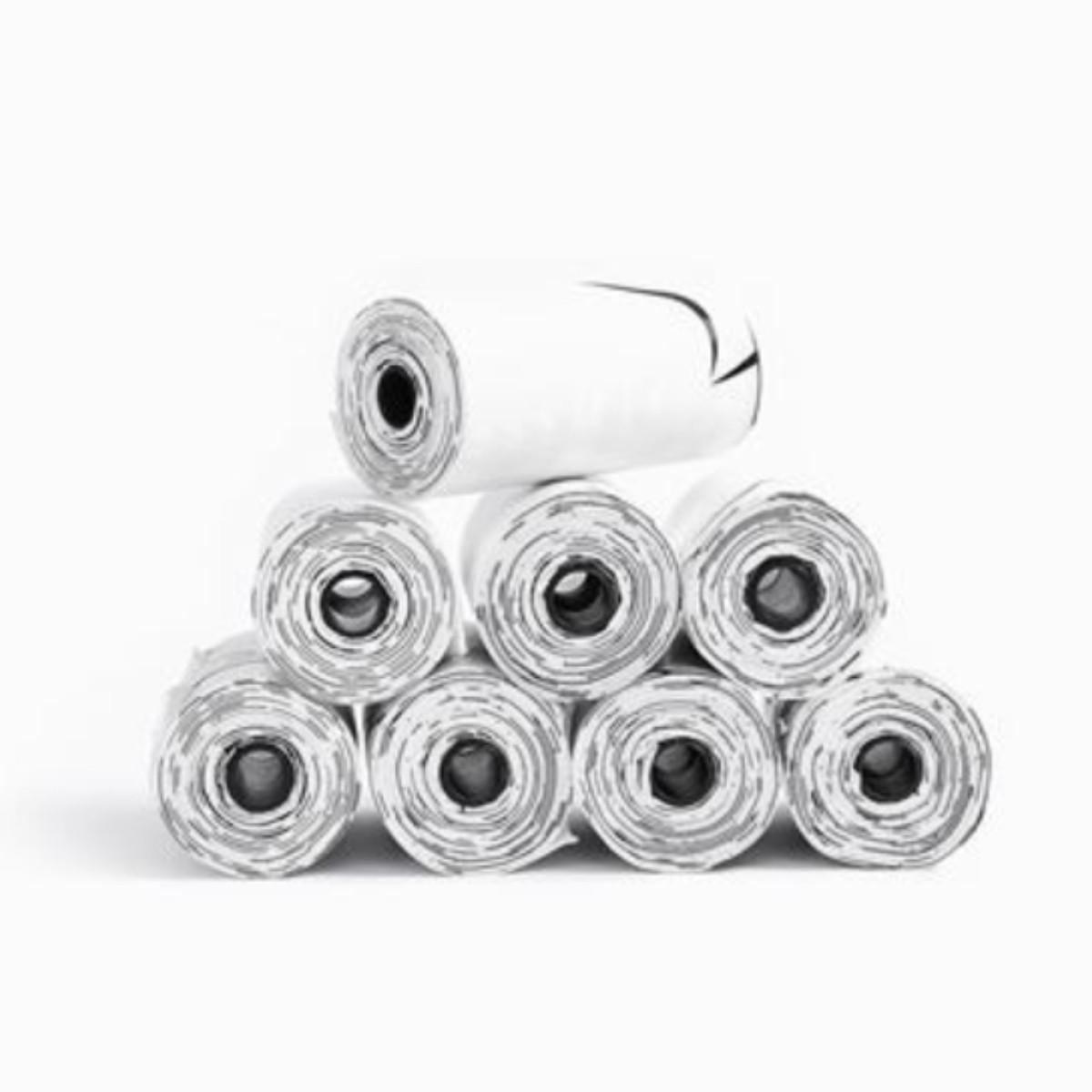 Rotoli impilati di materiale bianco con segni neri su sfondo bianco.