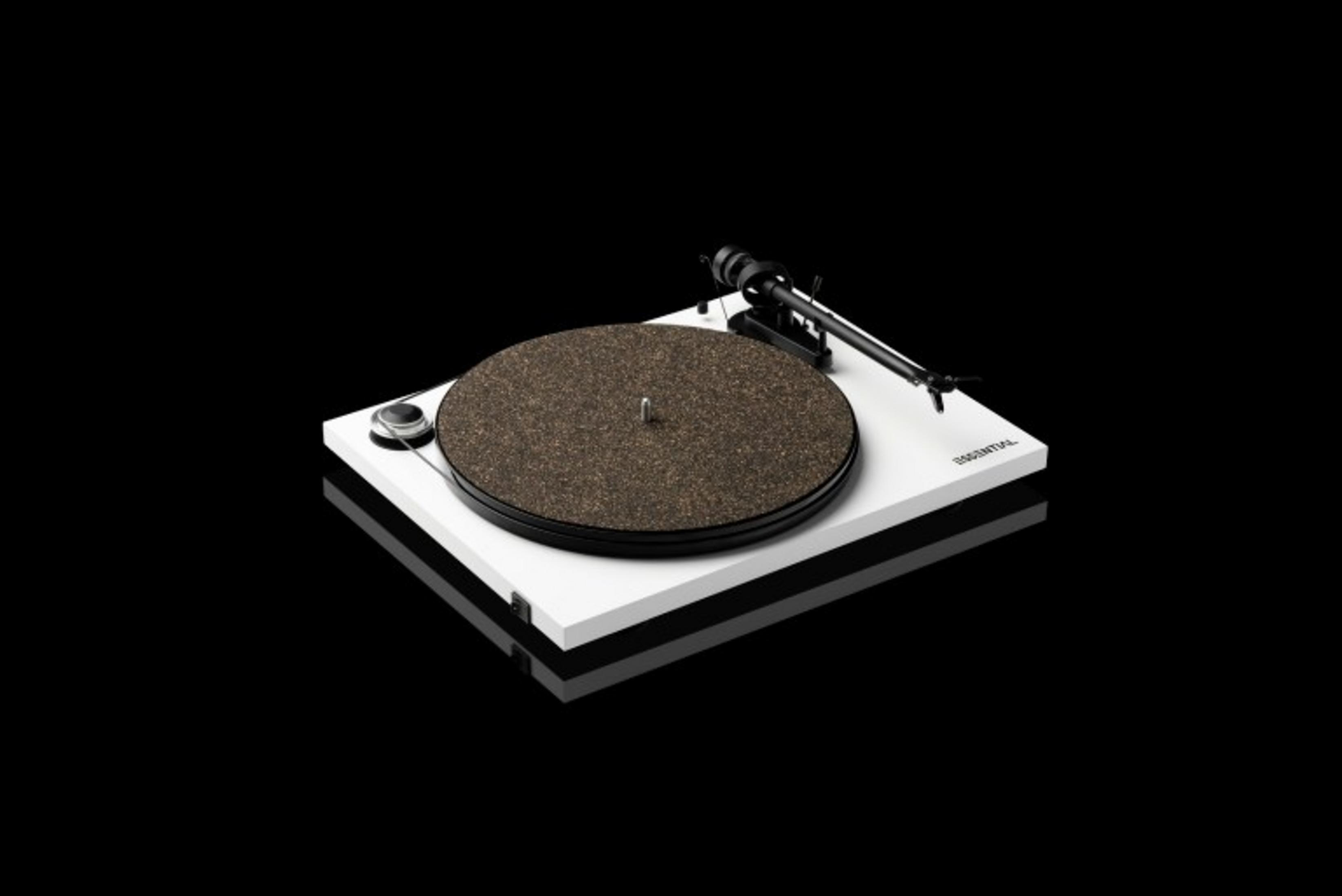 A white turntable with a black tonearm and a brown record mat.