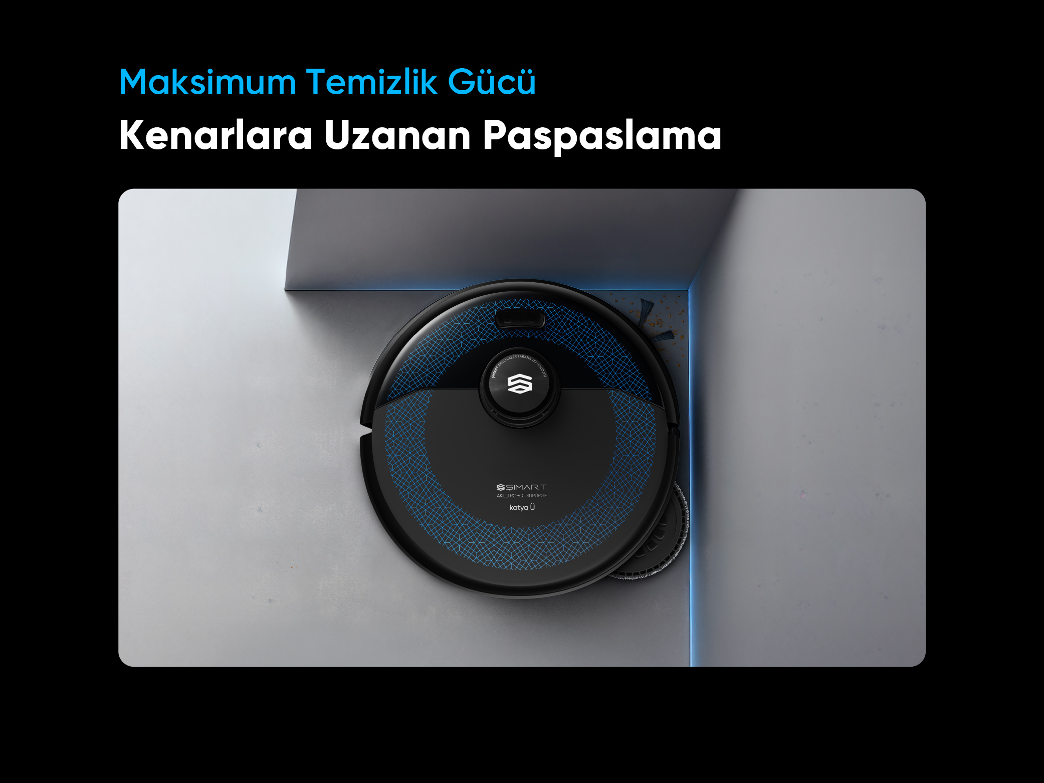 Mavi desenli siyah robot süpürge bir köşeyi temizliyor.