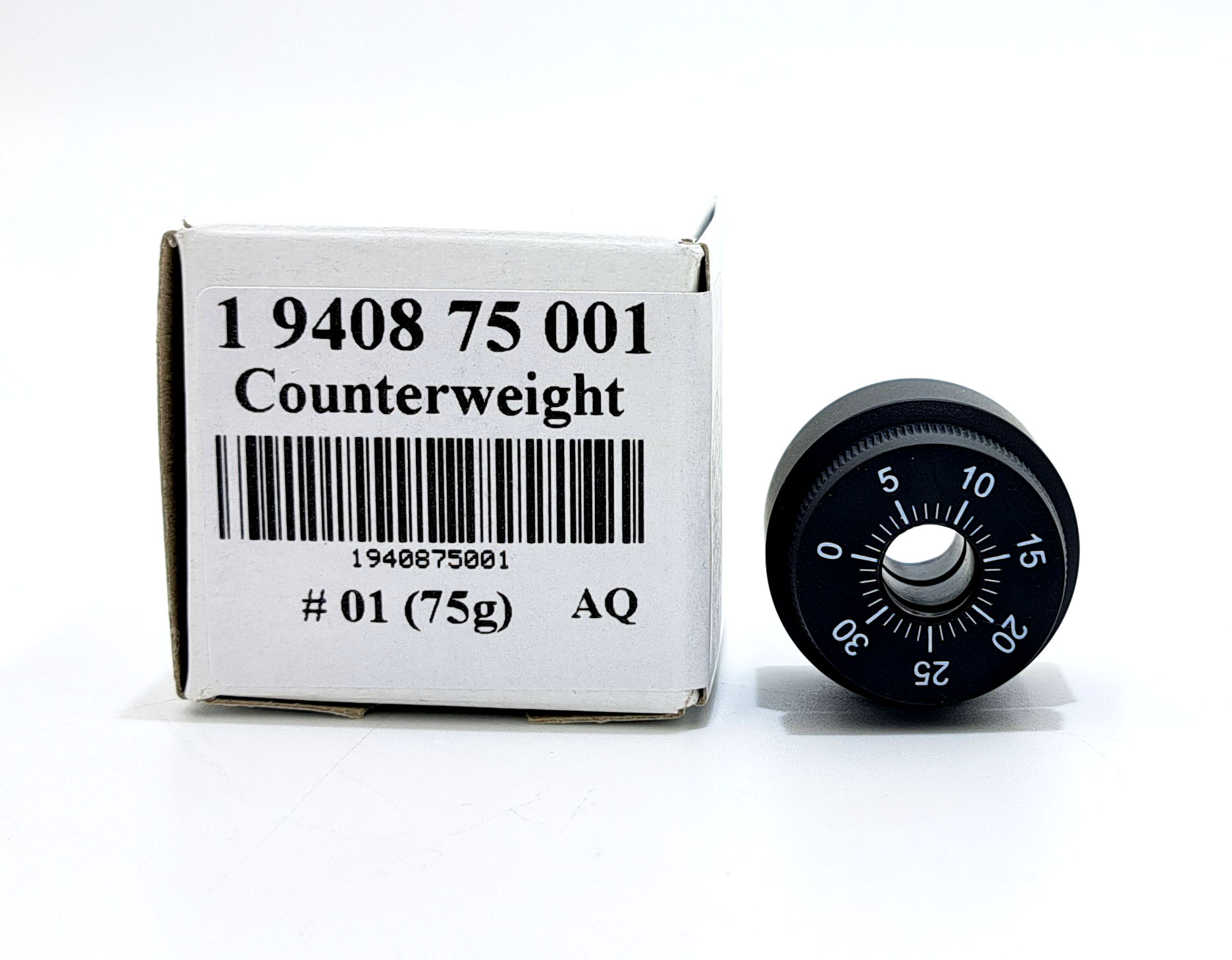 Pudełko z napisem "Przeciwwaga" i czarna przeciwwaga ze skalą.