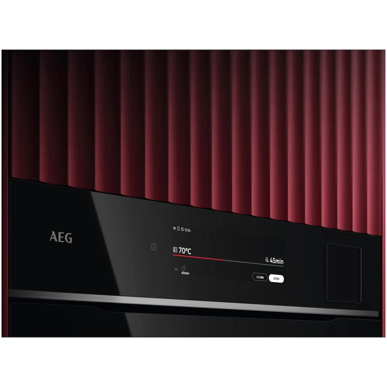 AEG oven against red ribbed wall, touchscreen shows 70°C and 45 min.