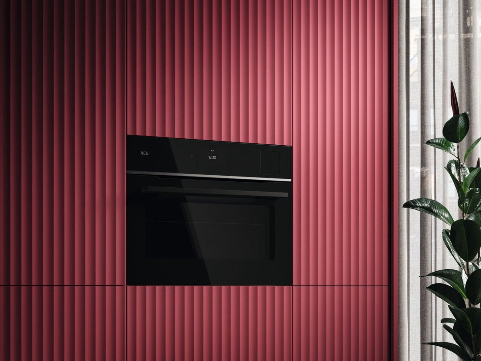 Un four encastrable moderne rouge avec façades rainurées verticales et panneau de commande noir.