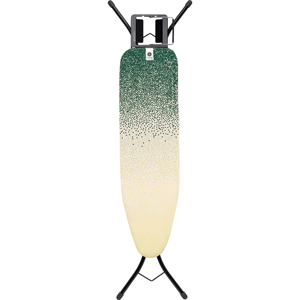 An ironing board with a green and yellow dotted pattern stands on black legs.