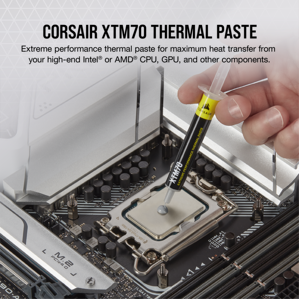 Eine Hand trägt weiße Wärmeleitpaste aus einer Spritze auf eine CPU auf einem Motherboard auf.