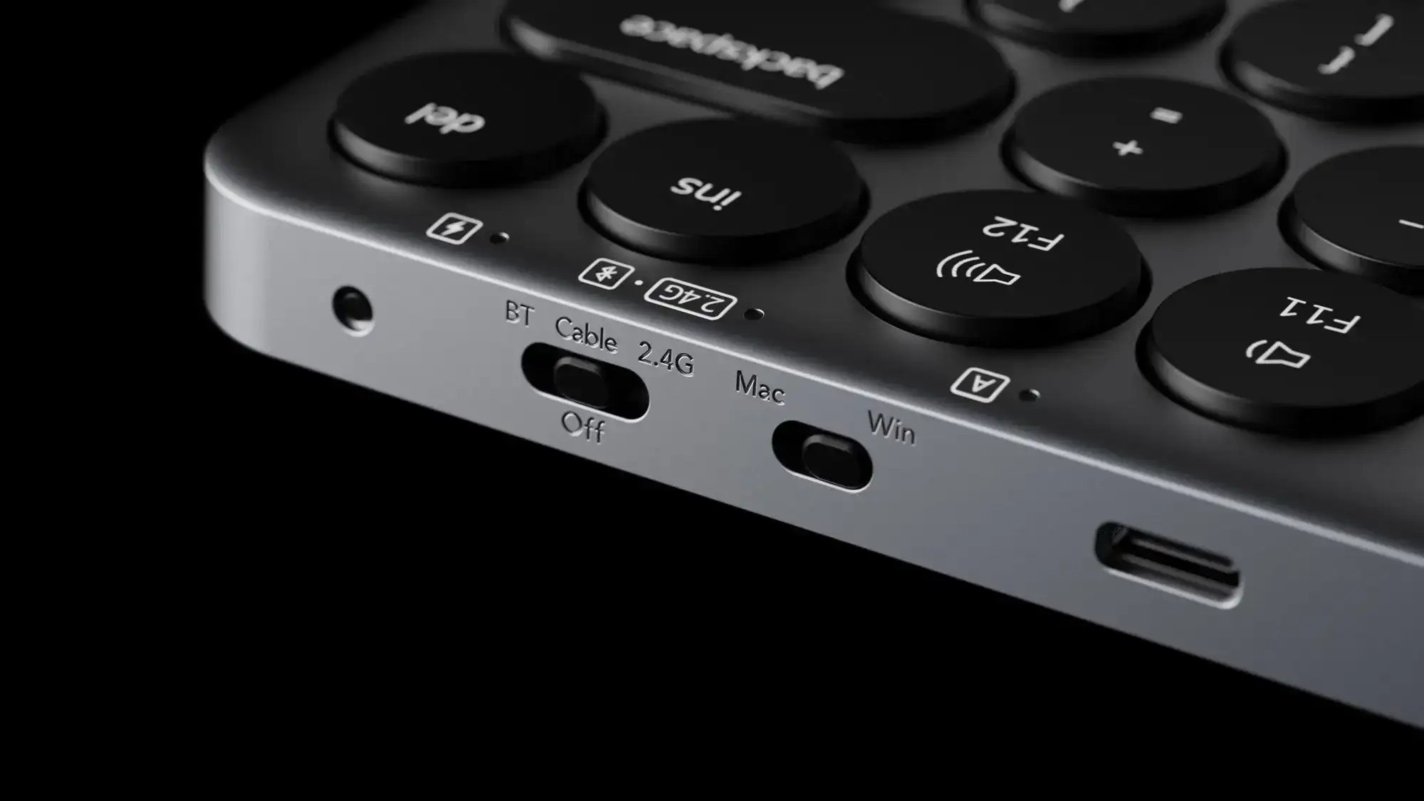 Szara klawiatura z okrągłymi klawiszami, przełącznikami i portem USB-C.