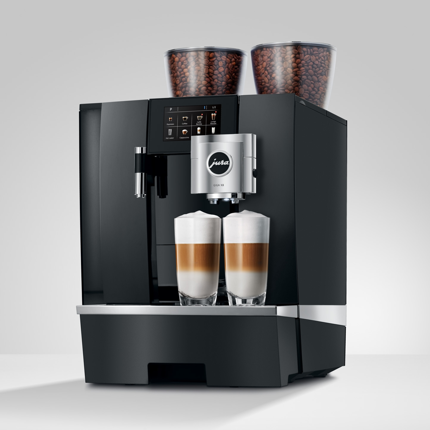 Una macchina da caffè Jura Giga X8 nera con due tramogge per chicchi trasparenti e due latte.