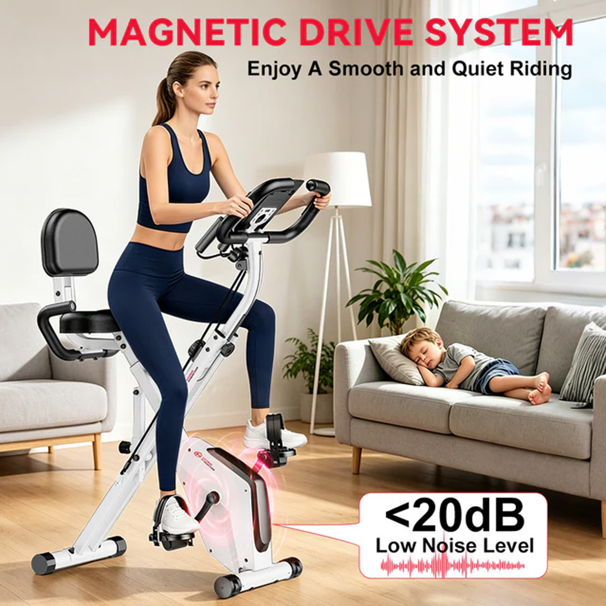 Kobieta na rowerze stacjonarnym, dziecko śpi na kanapie. Niski poziom hałasu.