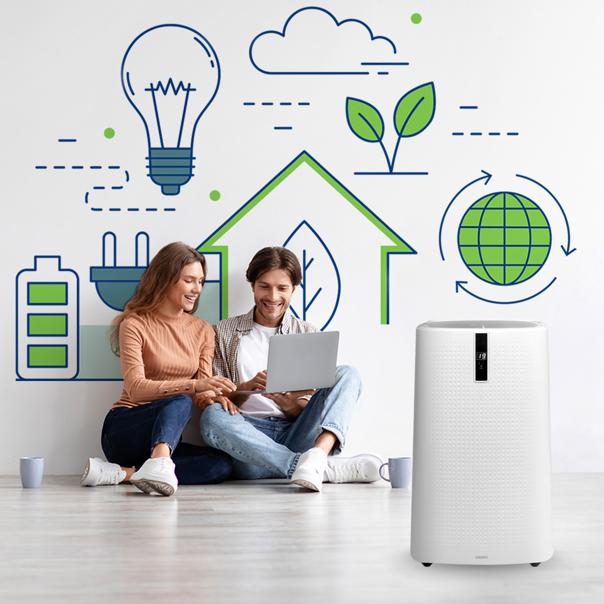 Para siedzi na podłodze, korzystając z laptopa przed ścianą z ikonami energii. Obok stoi oczyszczacz powietrza.