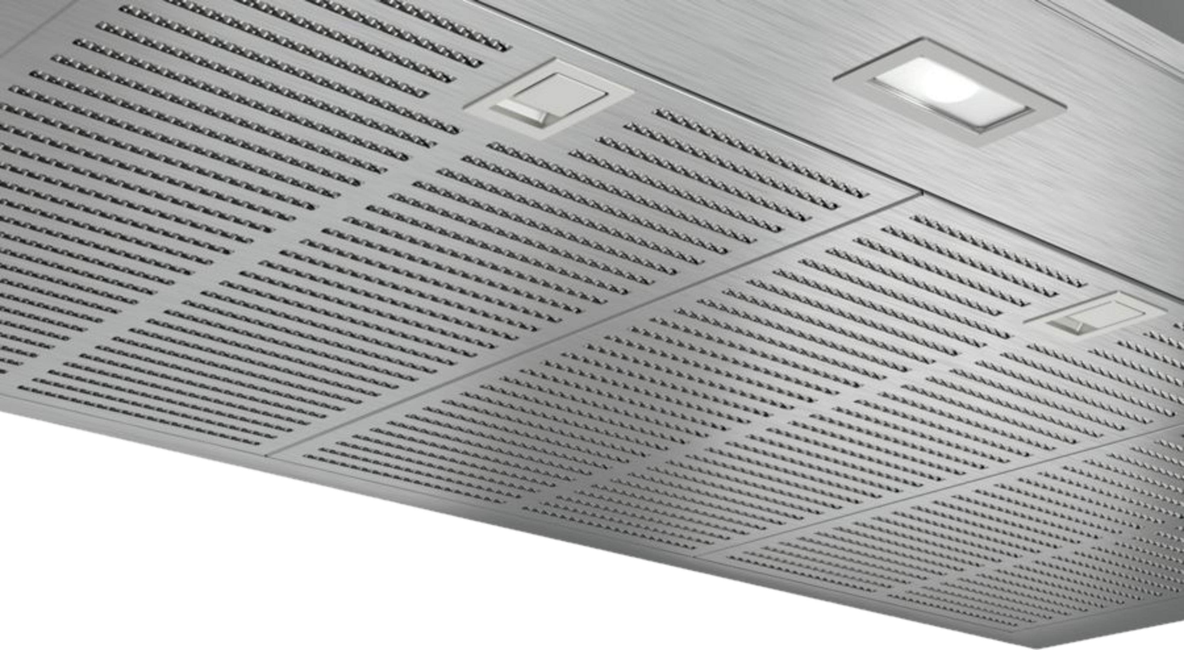 Campana extractora de acero inoxidable con rejillas de ventilación y dos luces.