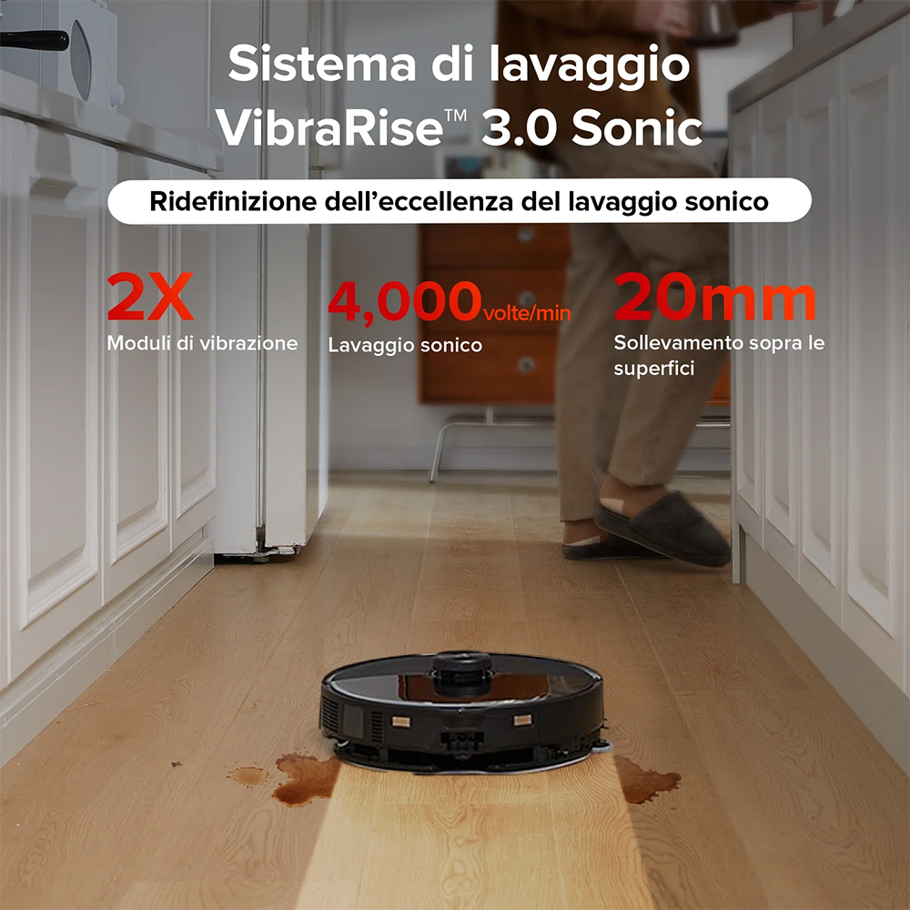 Czarny robot sprzątający czyści drewnianą podłogę przy szafkach kuchennych.