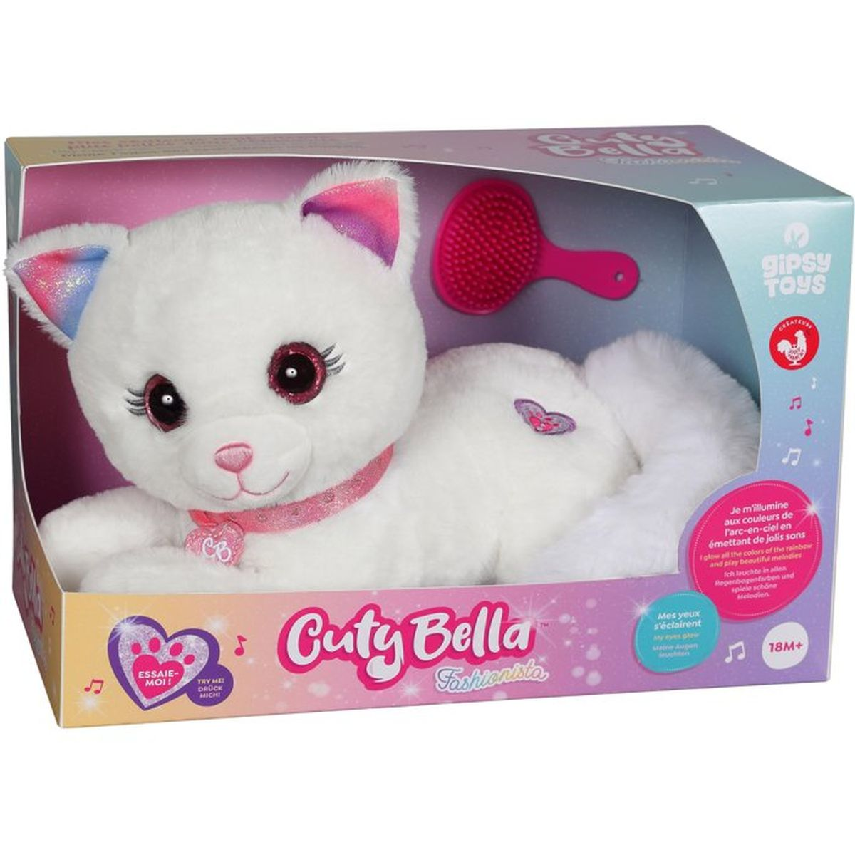 Ein weißes Plüschtier einer Katze mit Glitzeraugen in einer Box mit Kamm.