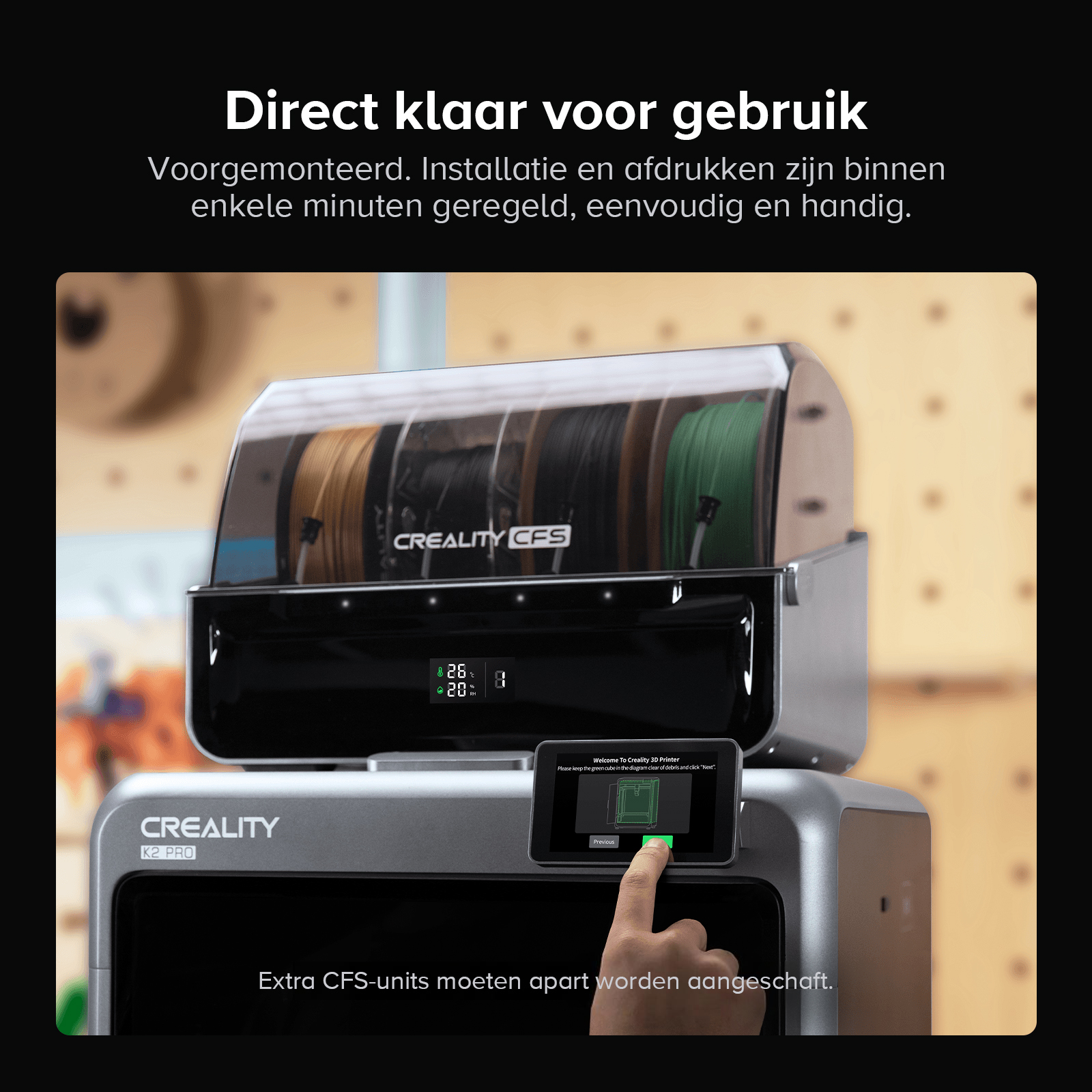 A 3D printer with filament spools inside a housing. A finger taps the screen.