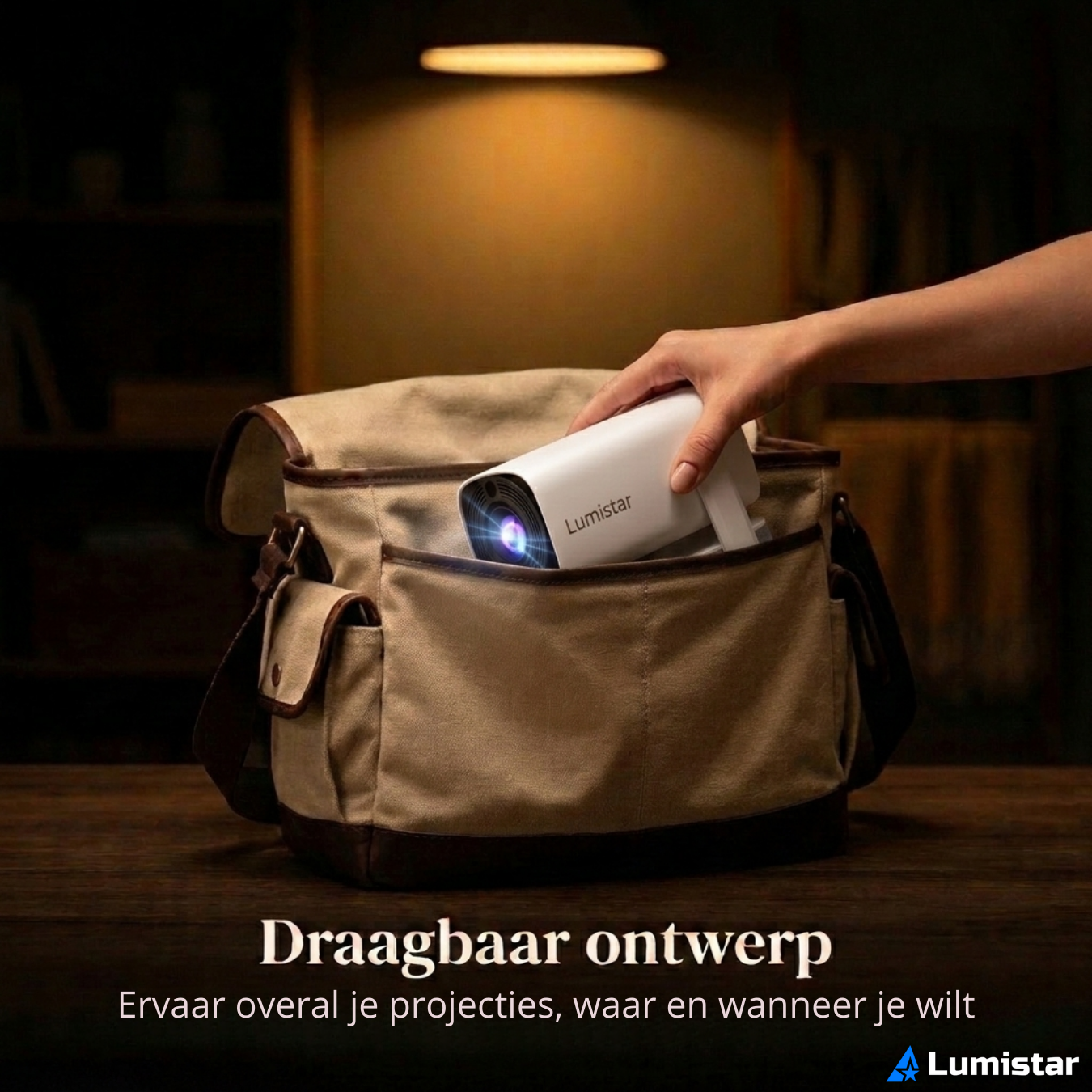 A hand places a white Lumistar projector into a canvas bag against a dark background.