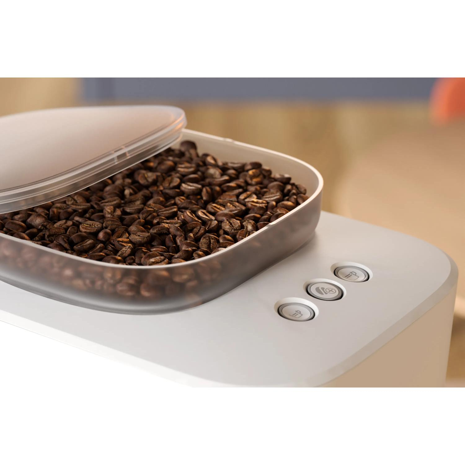 Ein transparenter Behälter voller Kaffeebohnen steht auf einer weißen Maschine mit drei Knöpfen.