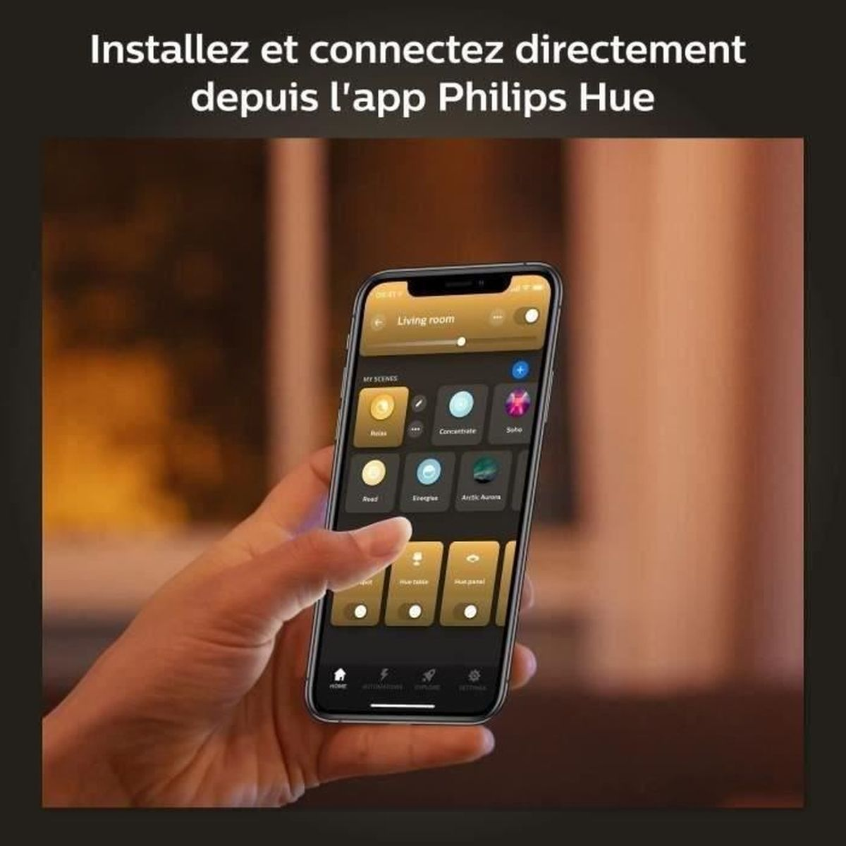 Dłoń trzyma smartfon z aplikacją Philips Hue. Ekran pokazuje sceny świetlne jak Relax i Concentrate.