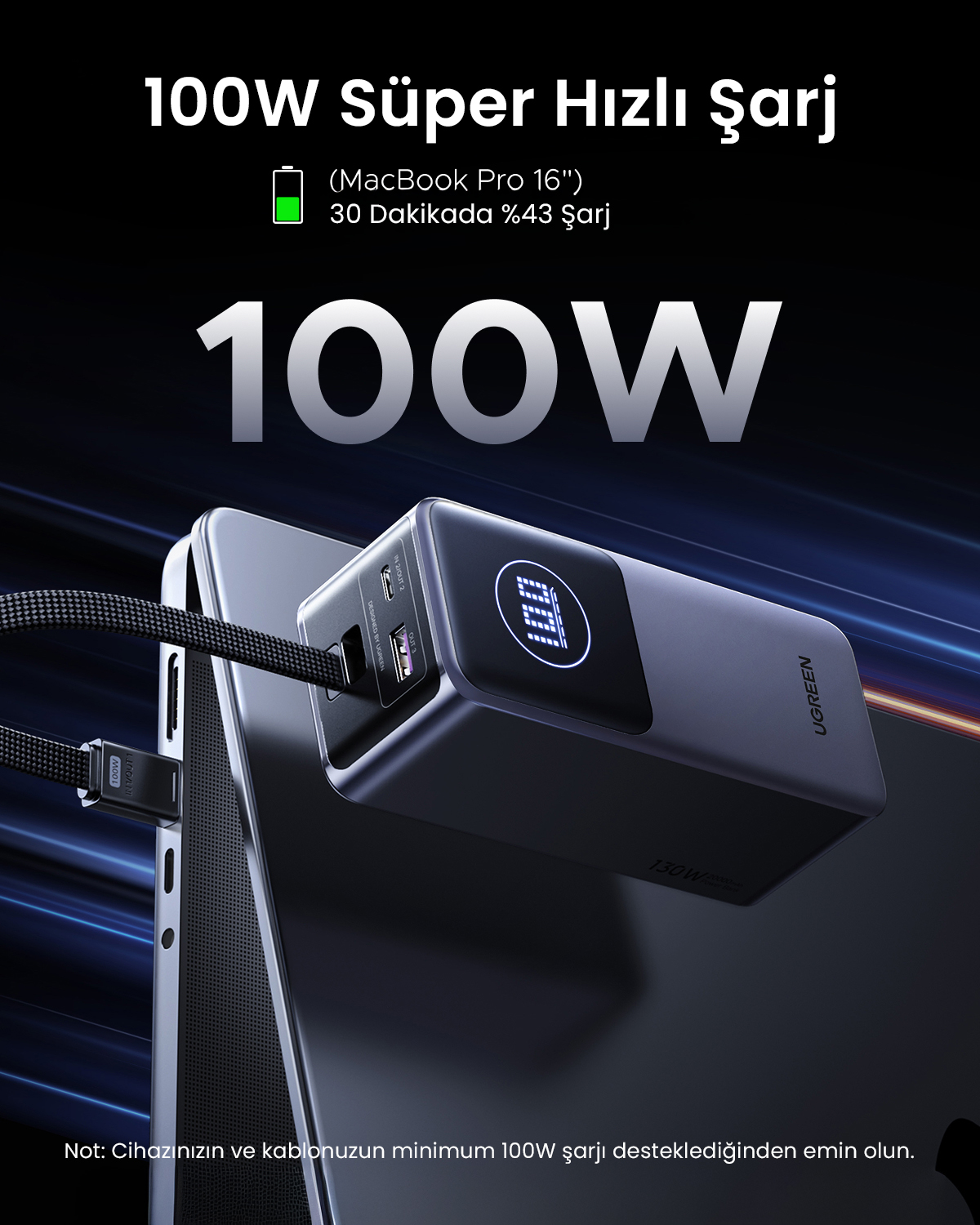 Czarny power bank ładuje MacBook Pro. Moc 100W jest widoczna.