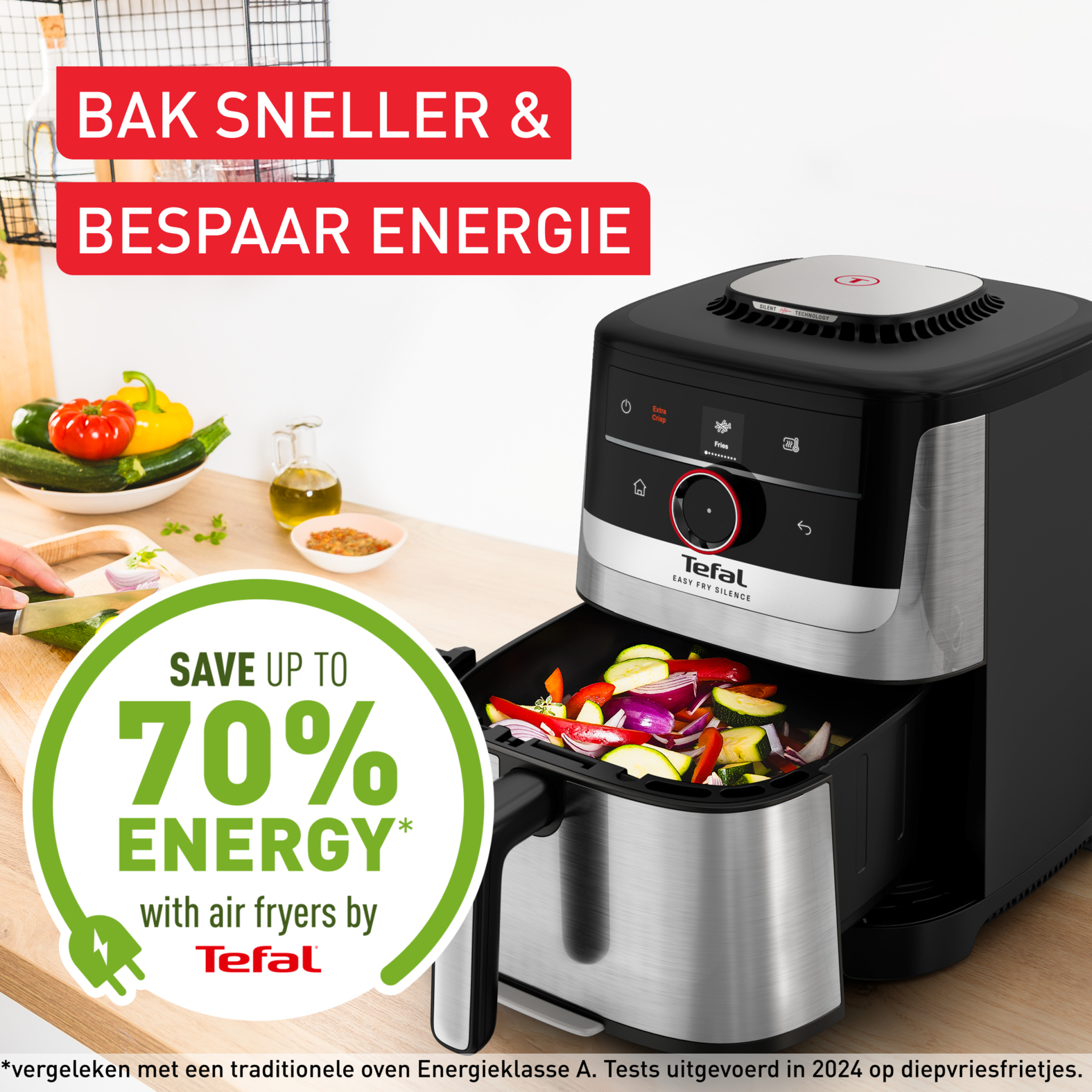 A Tefal air fryer with vegetables in the basket, next to an energy saving icon.