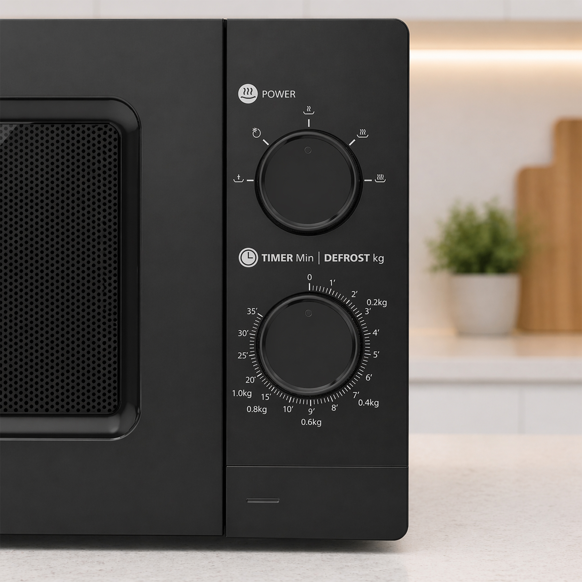 Black microwave with two dials for power and time/defrost settings.