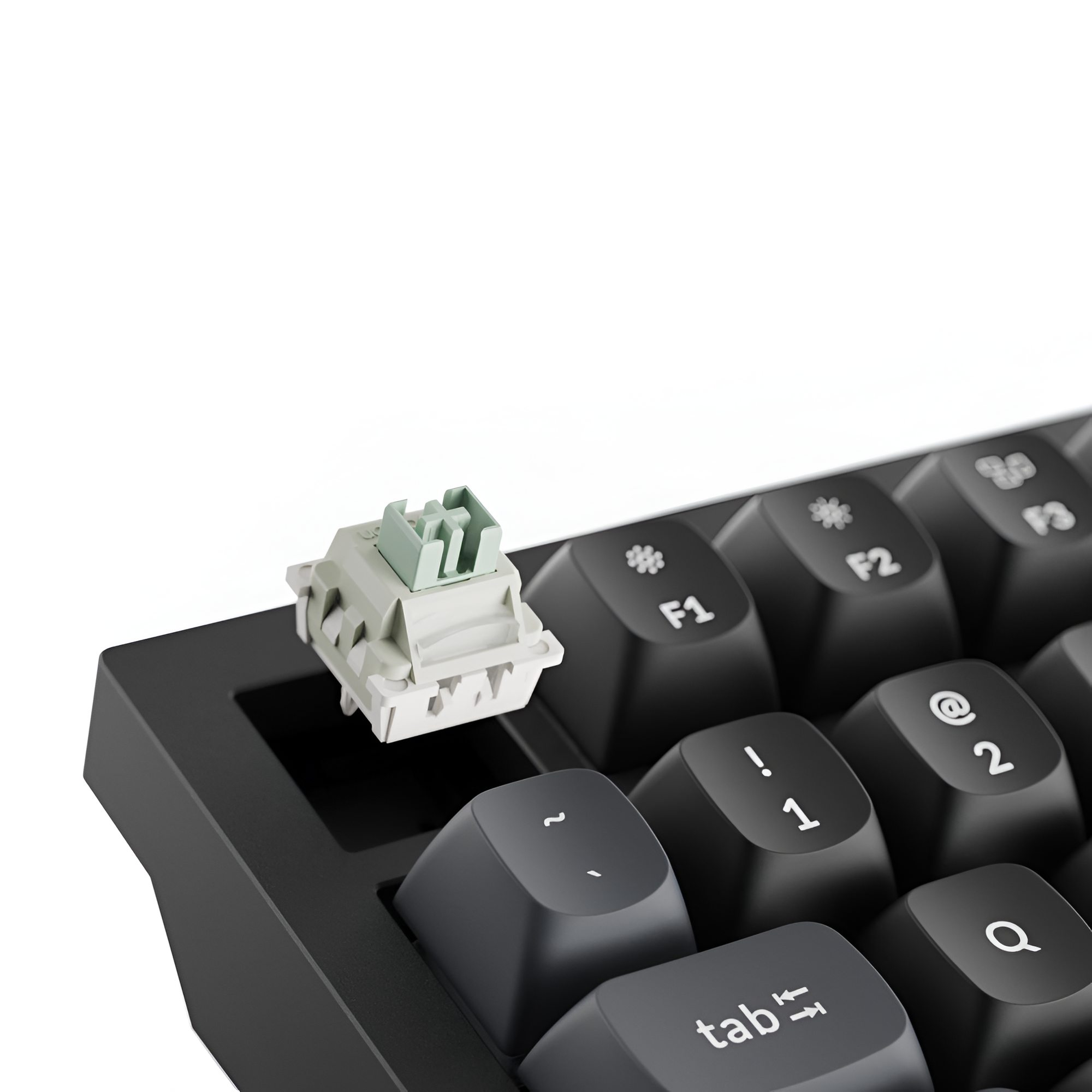 Szary przełącznik klawiatury z zielonymi akcentami na czarnej klawiaturze.